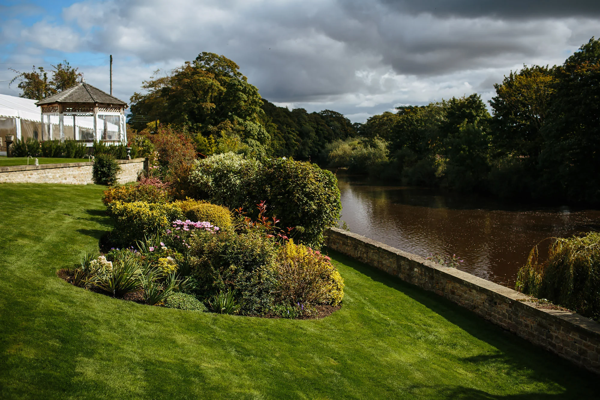 Flowers and bushes at Tanfield House in Yorkshire by the river