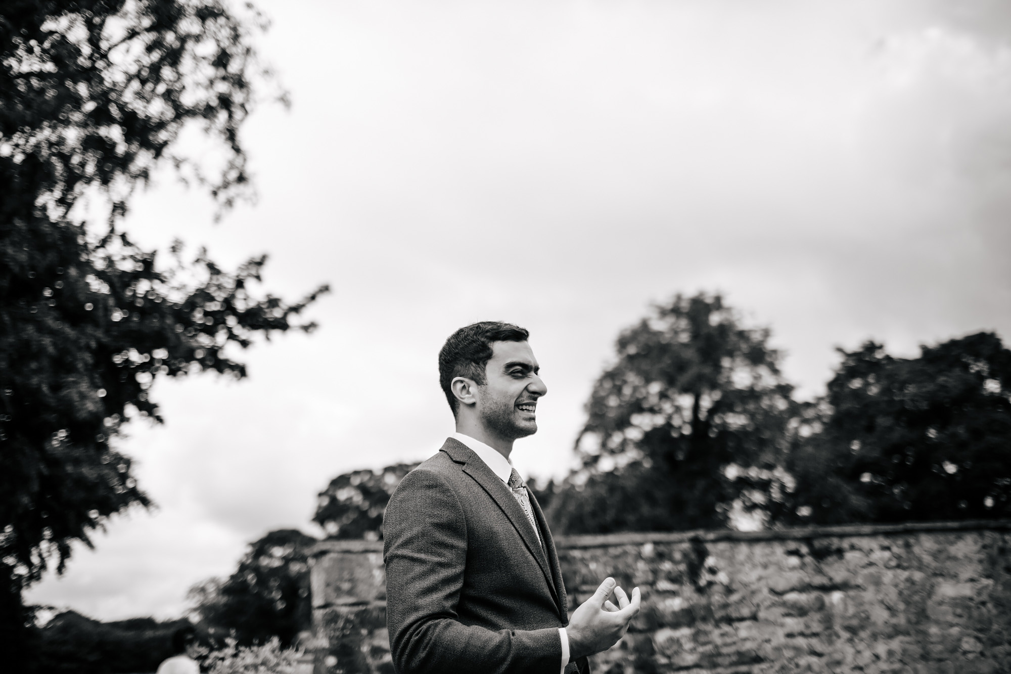 Black and white portrait of the groom laughing