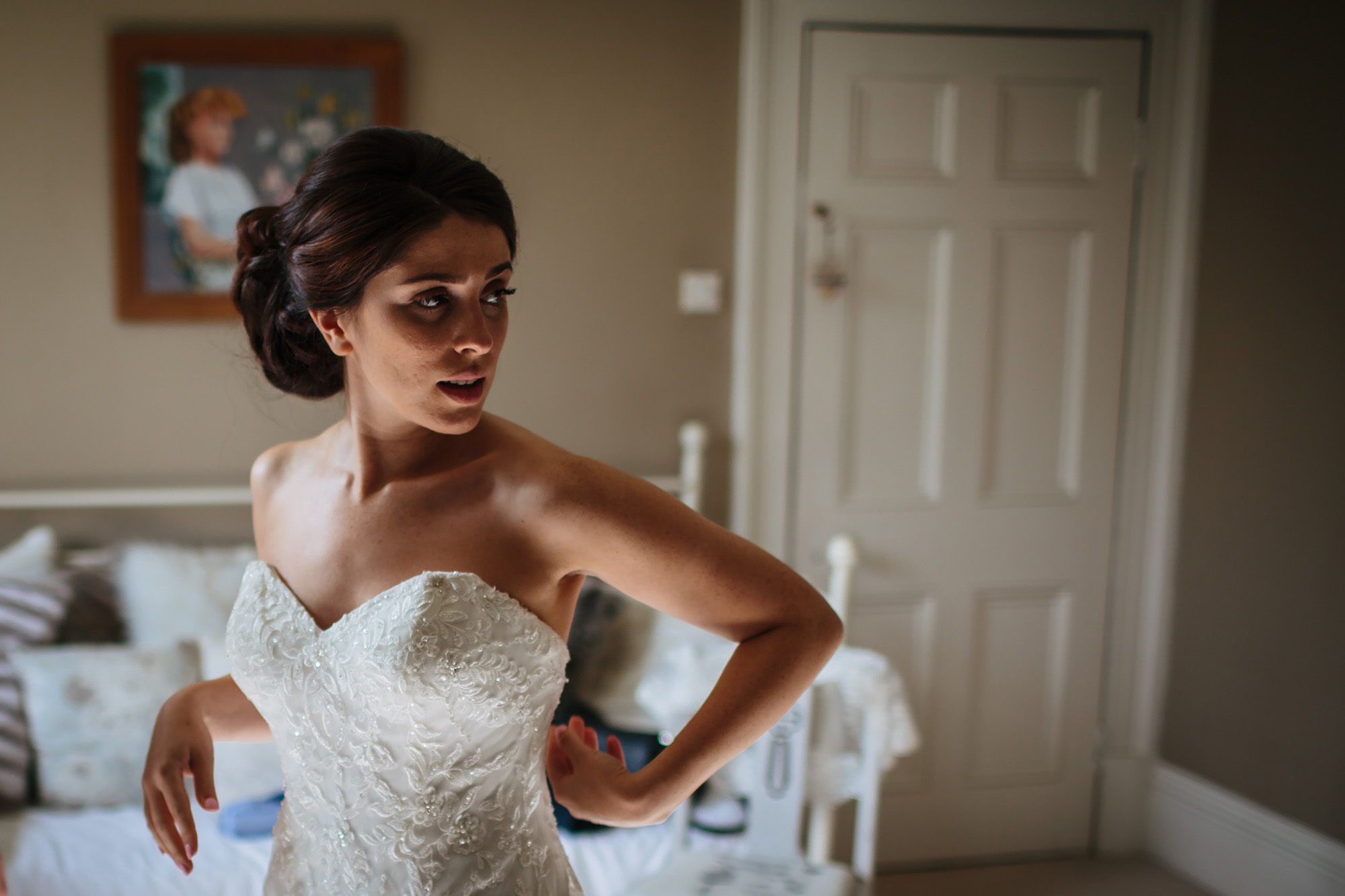 Pretty bride adjusting her wedding dress