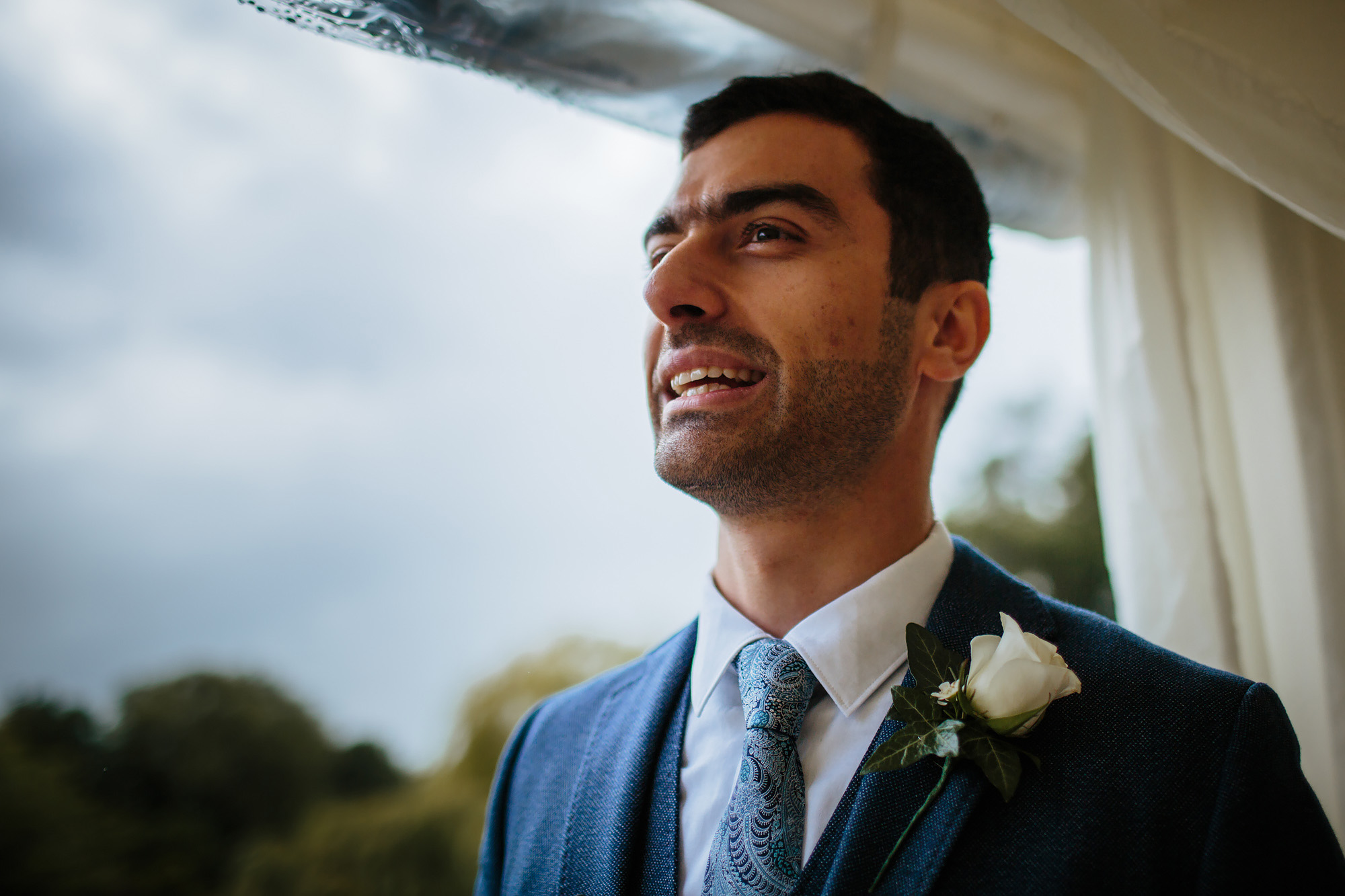 Groom portrait in his suit tie and buttonhole