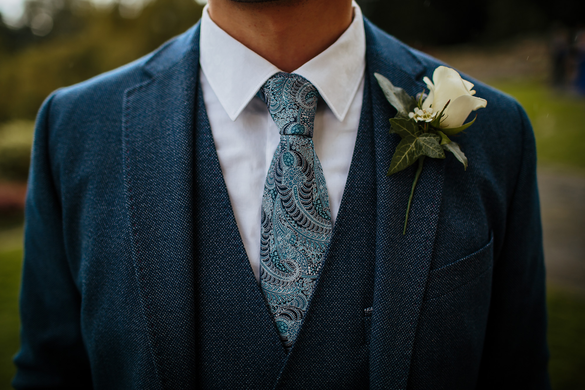 Close up of grooms suit with a buttonhole for the wedding