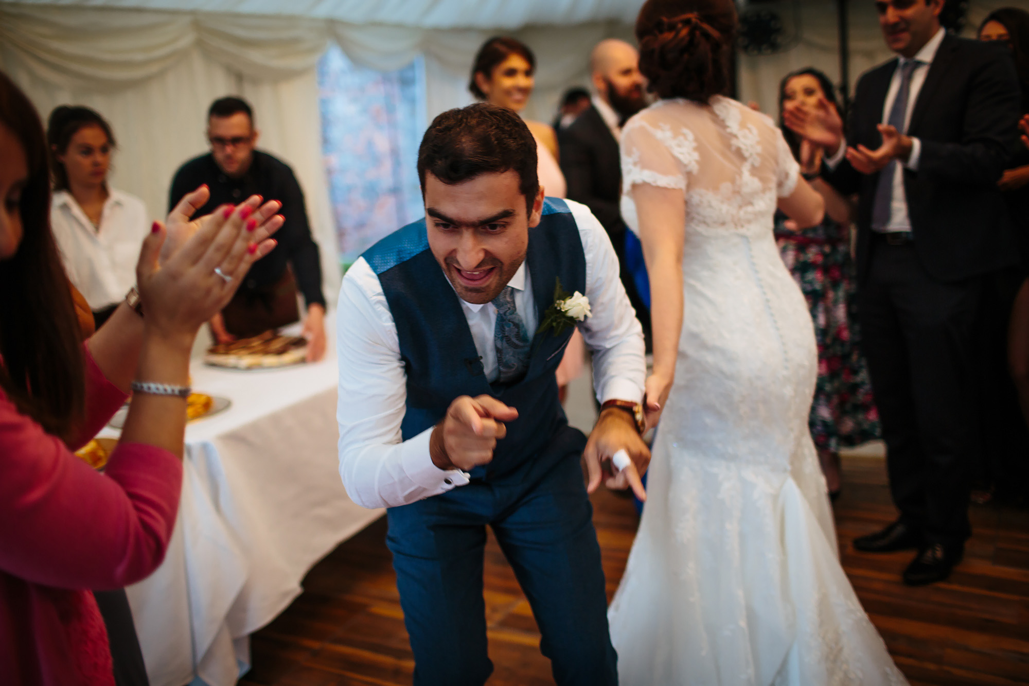Groom dancing at a wedding with a child