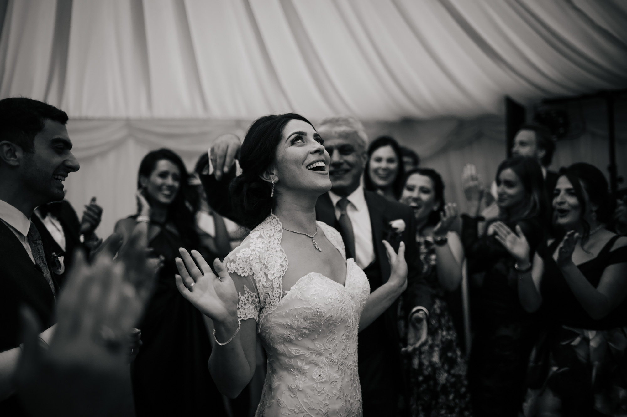 Bride dancing and laughing at a wedding