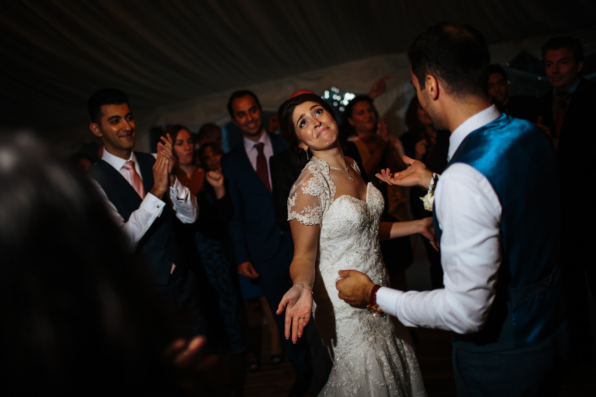 Bride laughing and dancing at a wedding