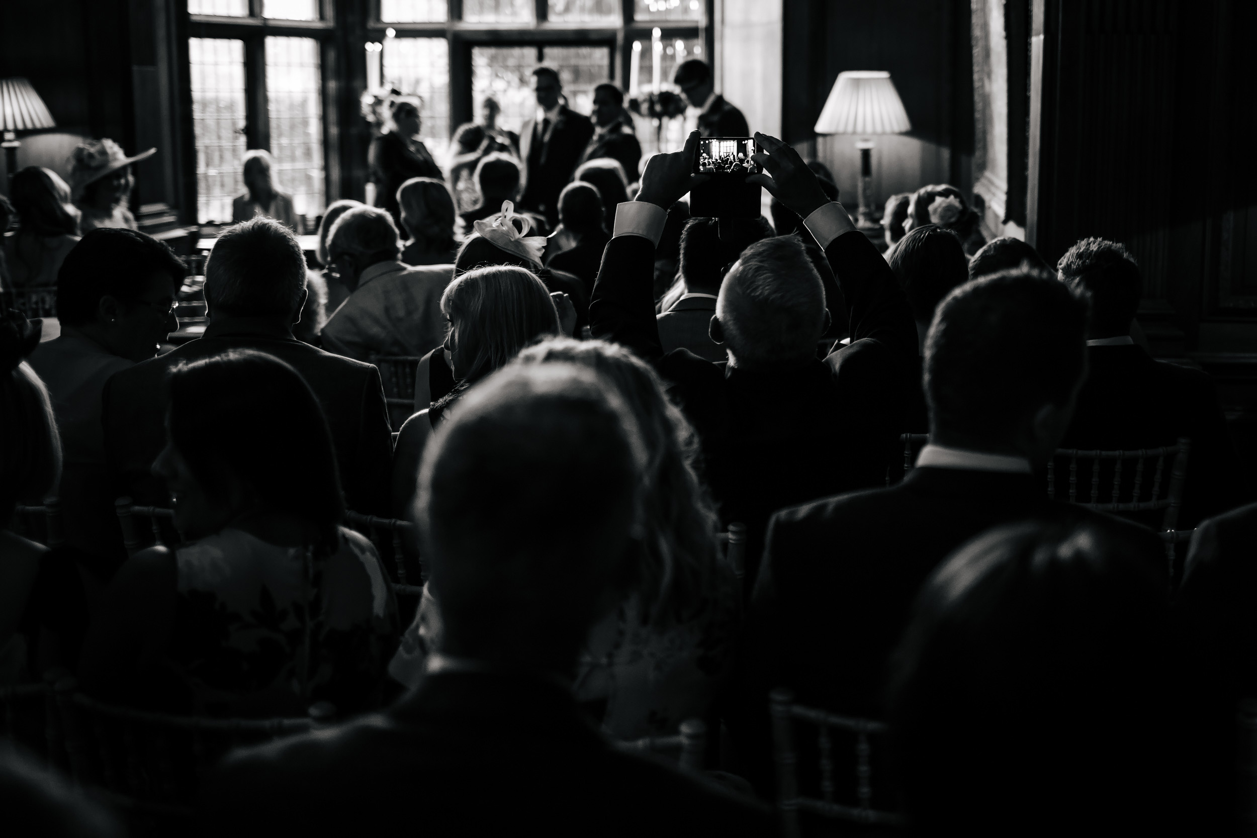 Black and white photo of guests at a wedding ceremony Thornton Manor