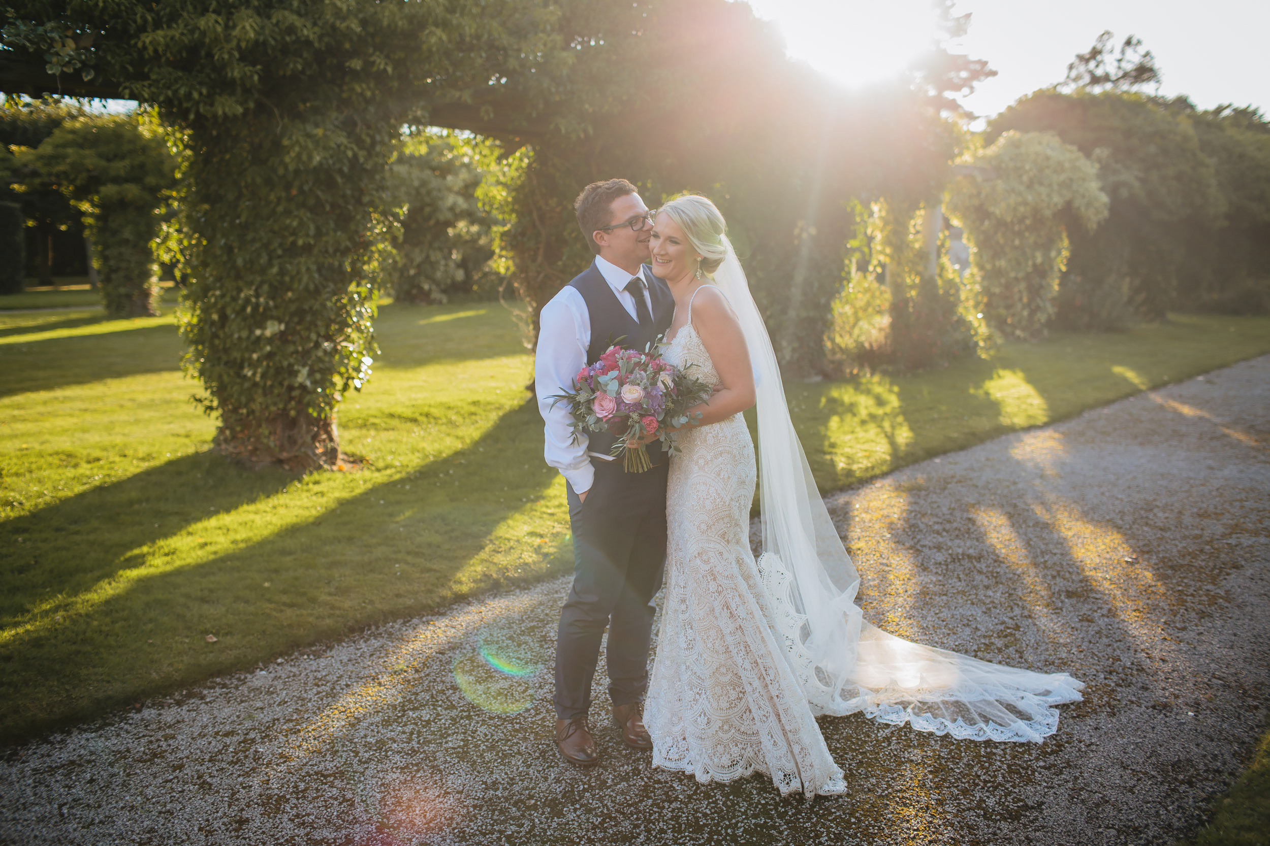 Bride and groom pose in the Cheshire sunshine