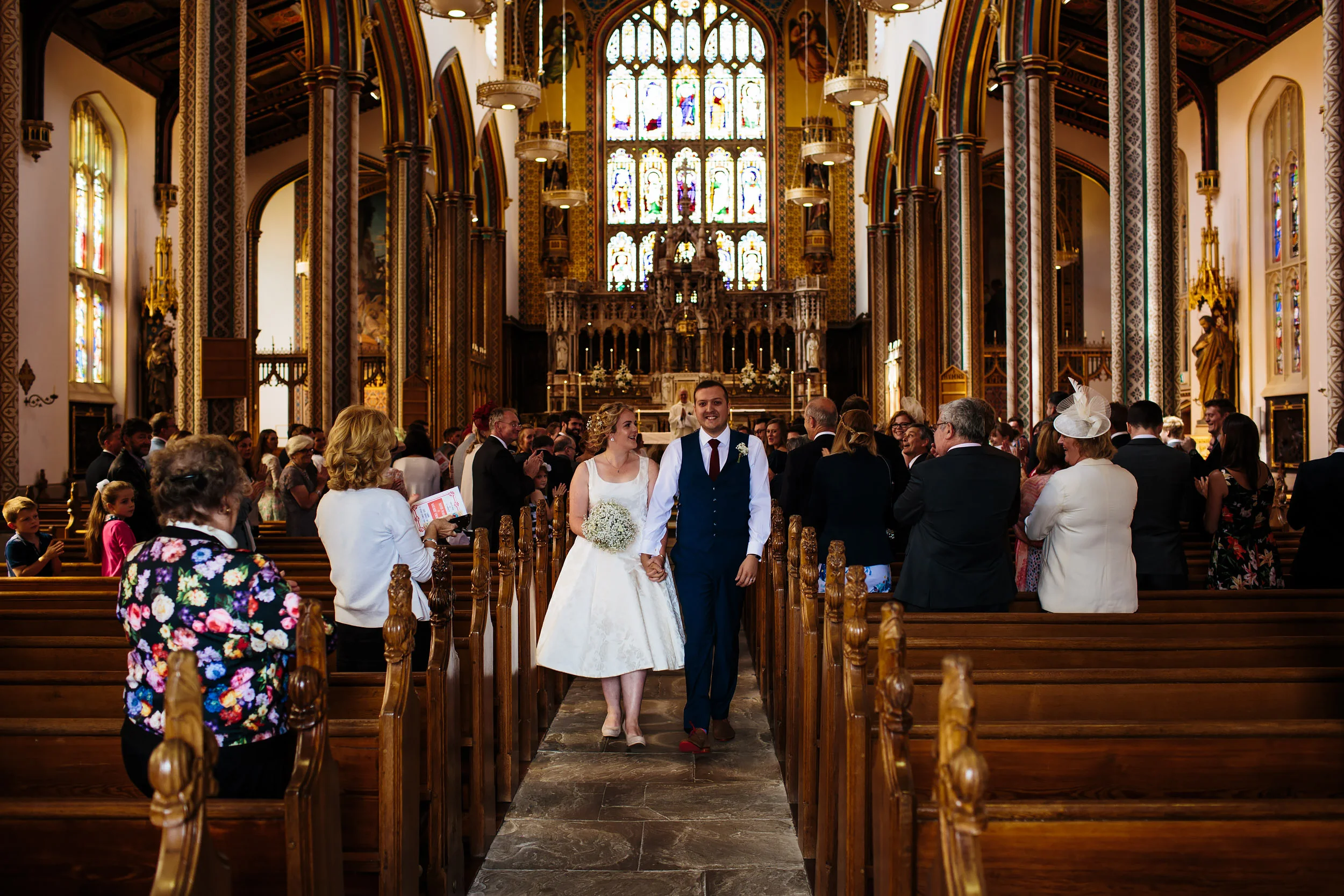 Bride and groom walk down the aisle at Stonyhurst College Wedding