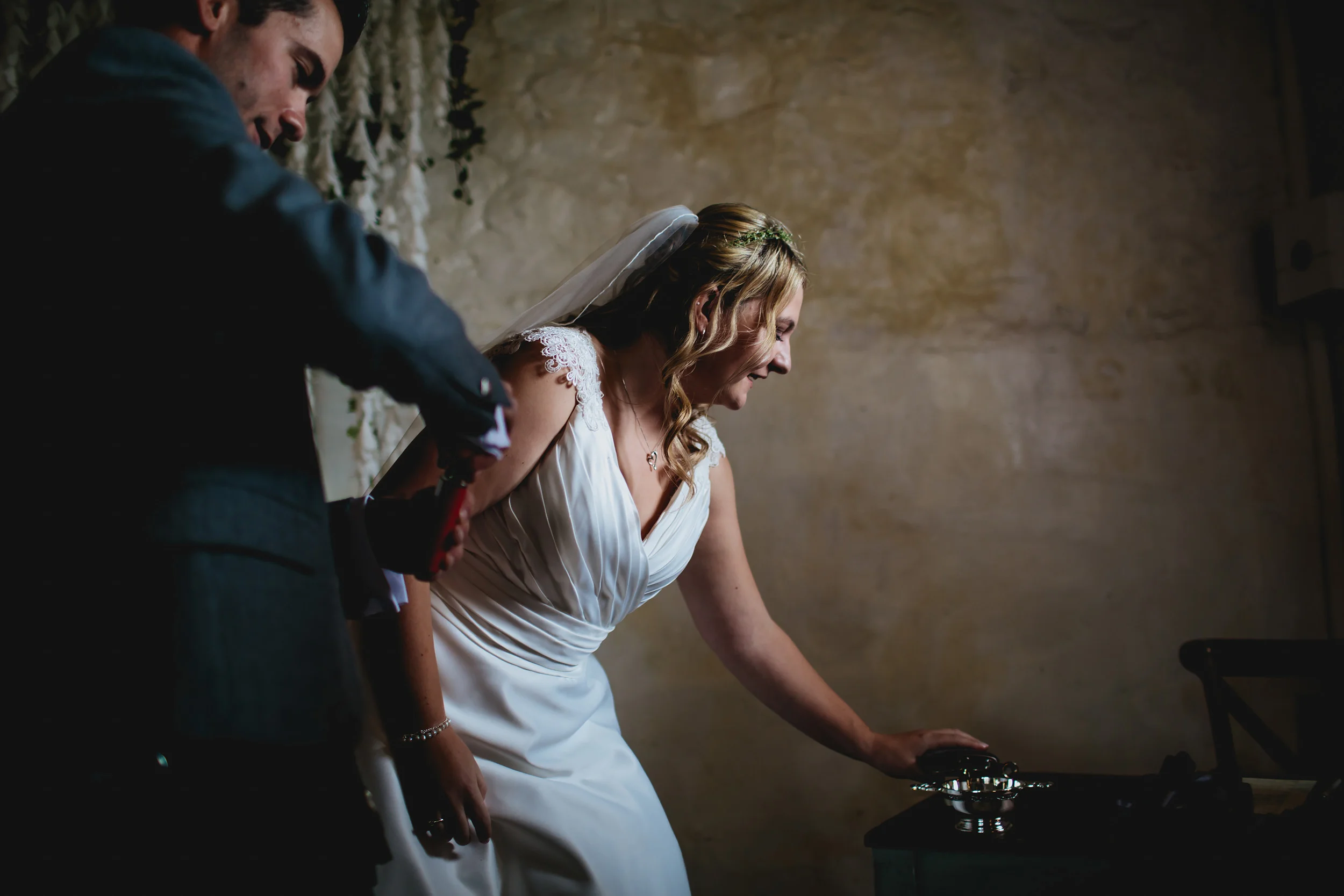 Bride pours whisky into a glass at Cow Shed Crail