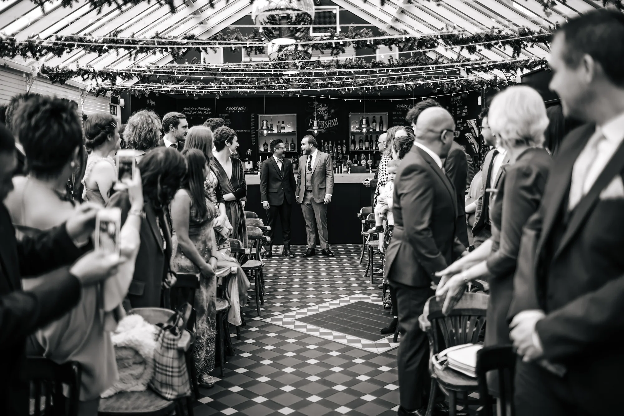 Grooms walking down the aisle at a gay wedding