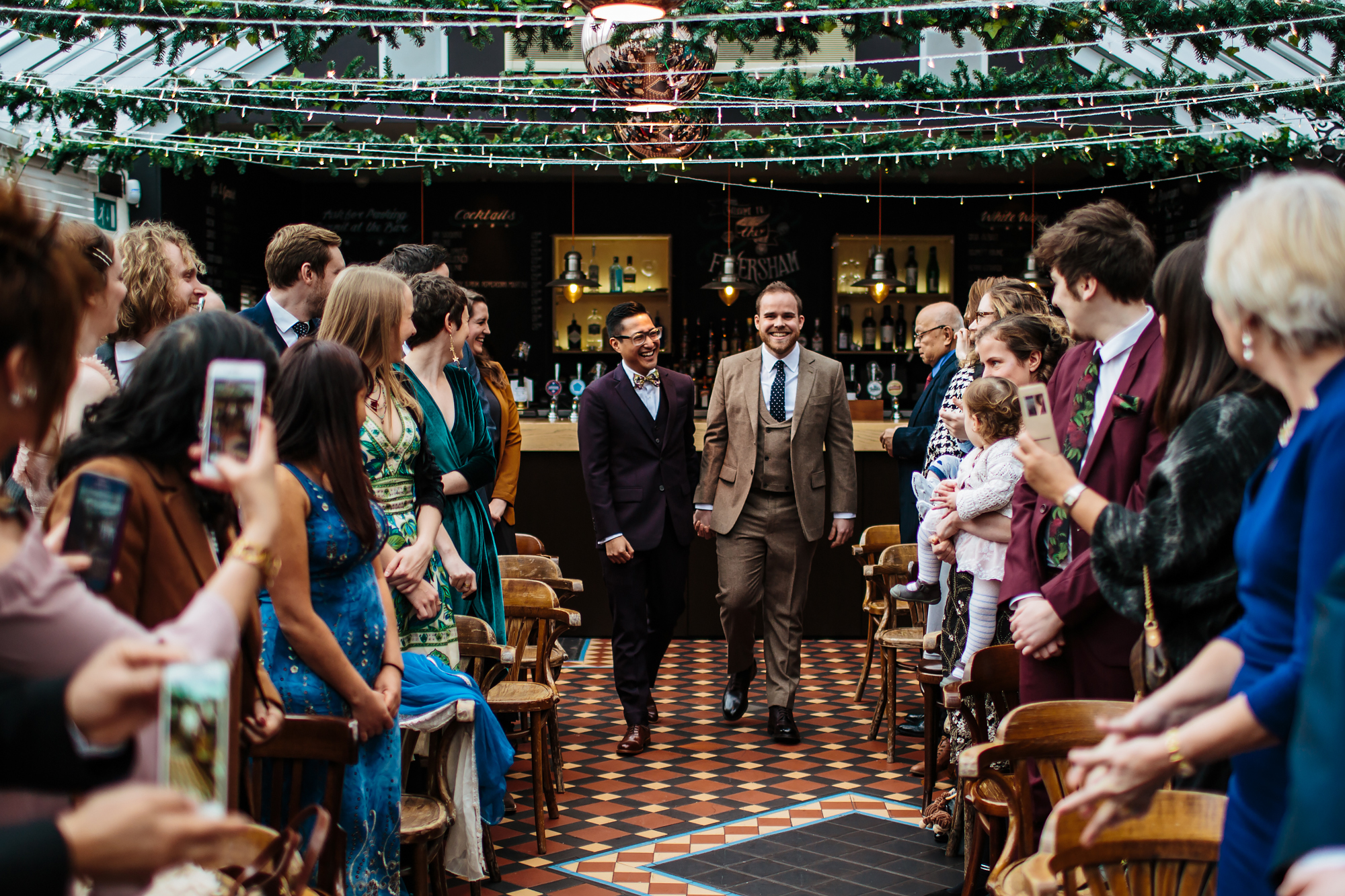 Grooms walk down the aisle at a gay wedding in Leeds