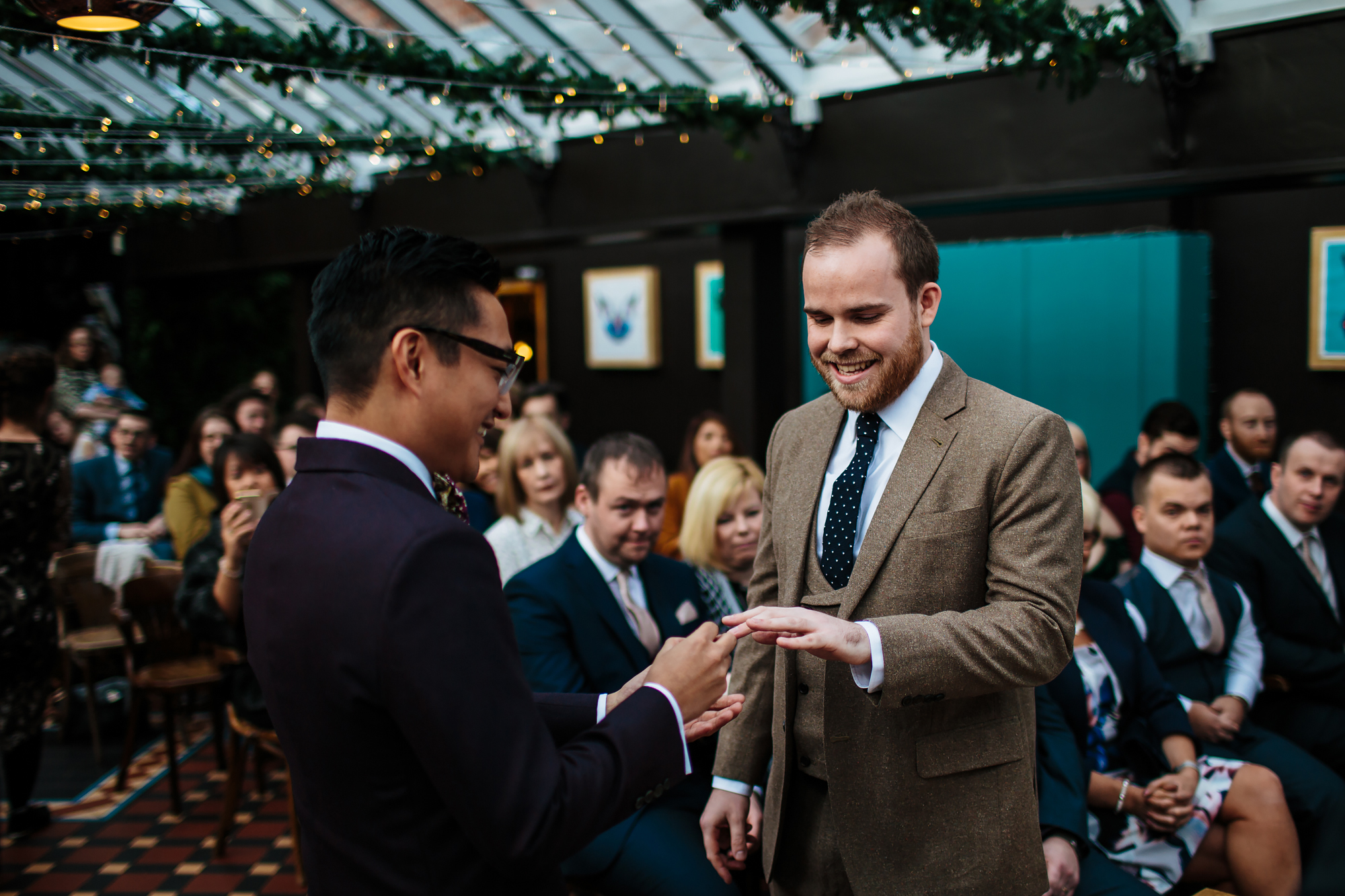 Groom placing the ring on his husband's finger in Yorkshire