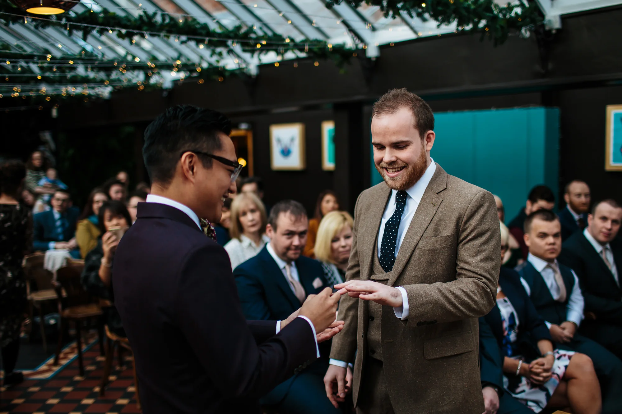 Groom placing the ring on his husband's finger in Yorkshire