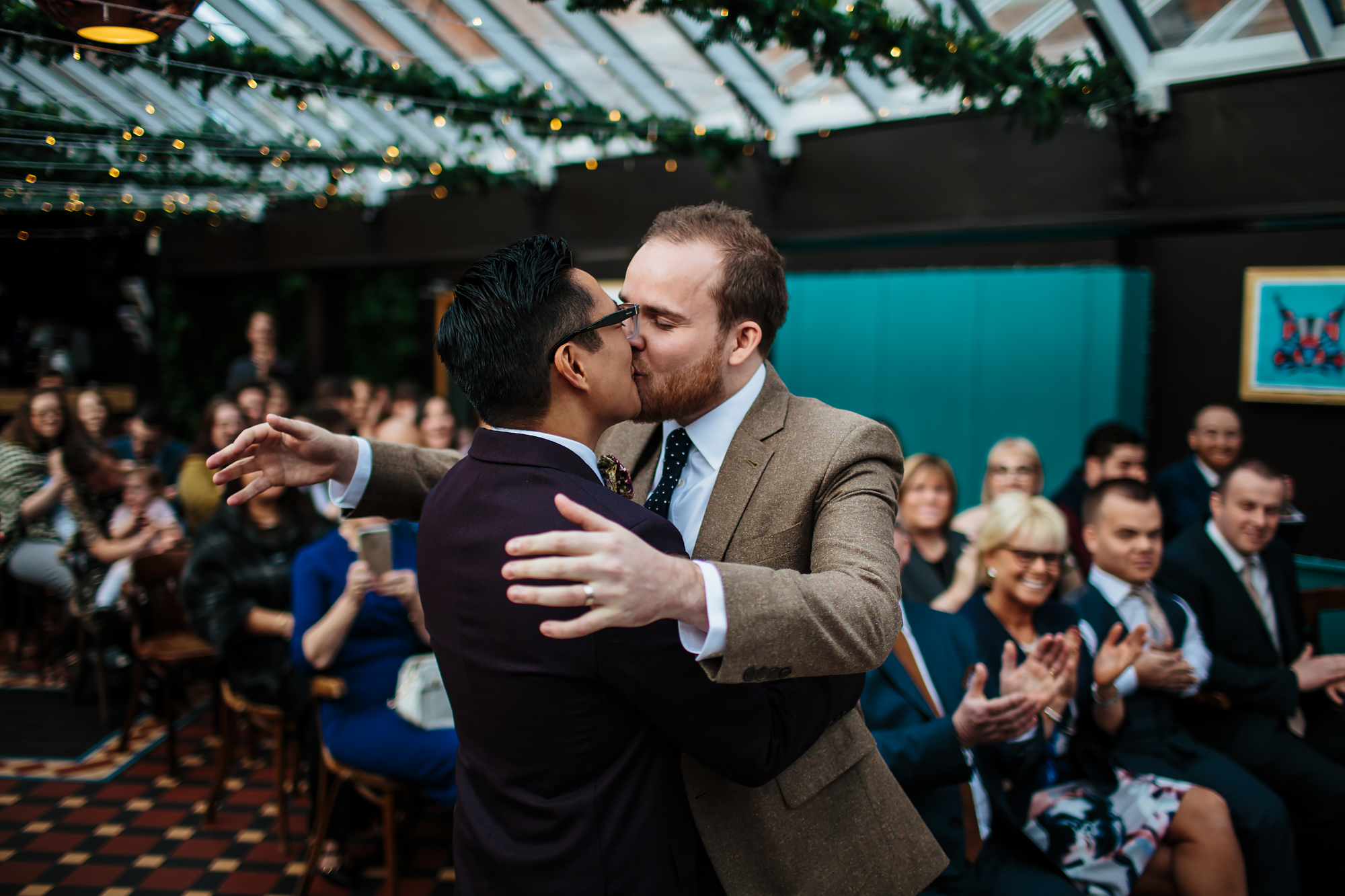 Grooms kissing at a gay wedding in Leeds