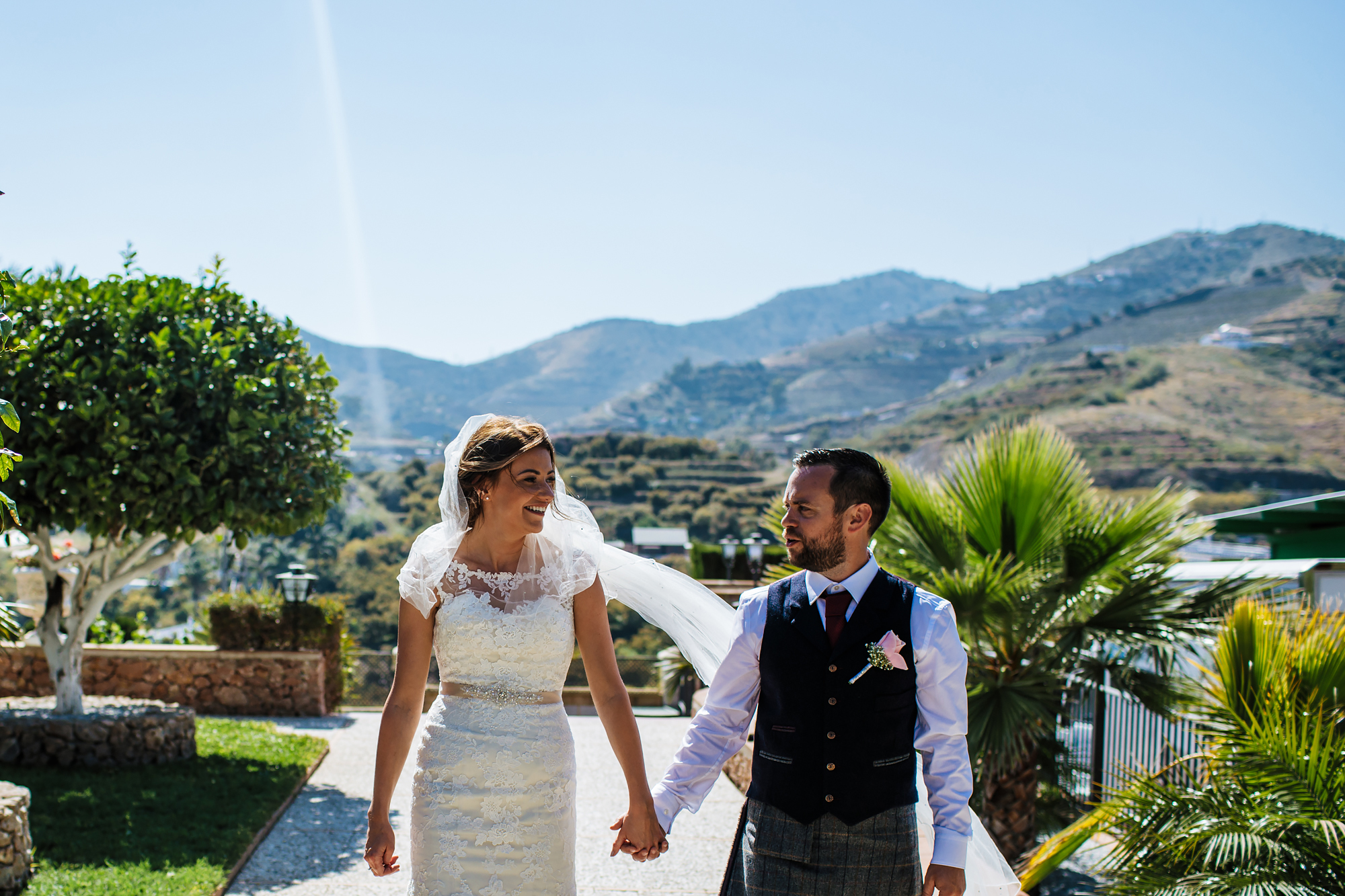 Bride and groom holding hands at Cortijo Maria Luisa Nerja Spain