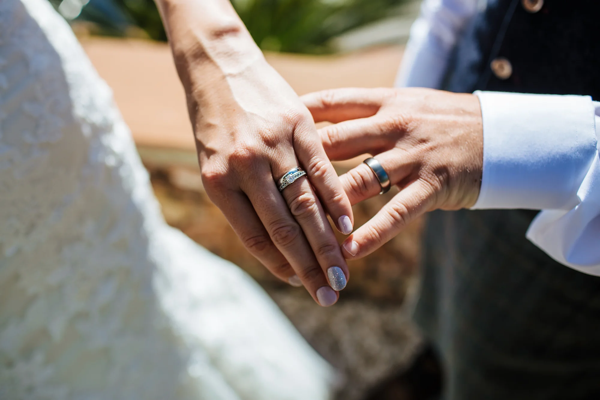 Wedding rings and hands at destination wedding in Nerja Spain