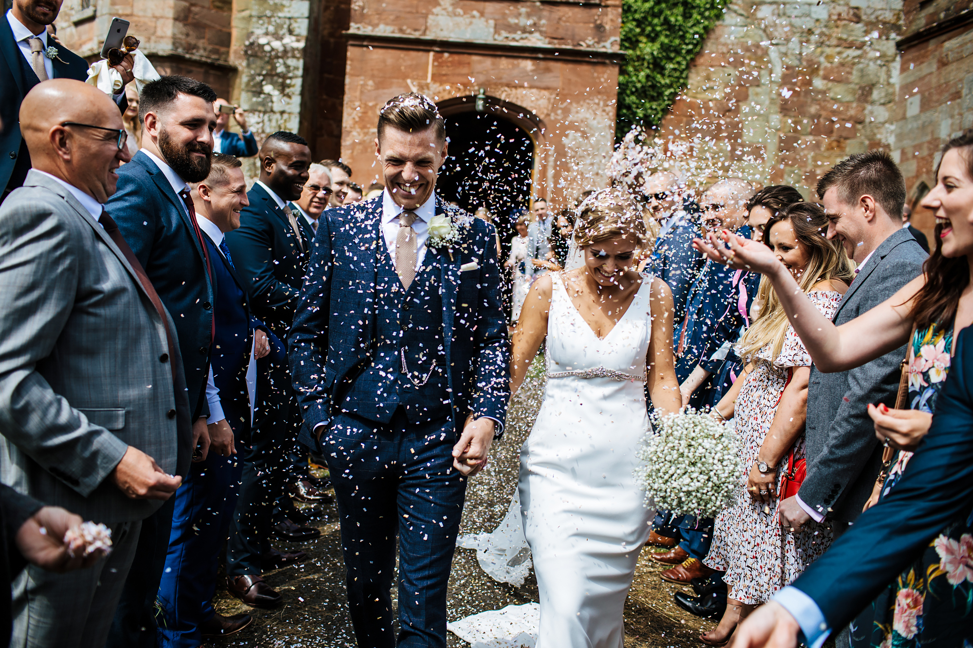 Bride and groom with confetti at a church wedding