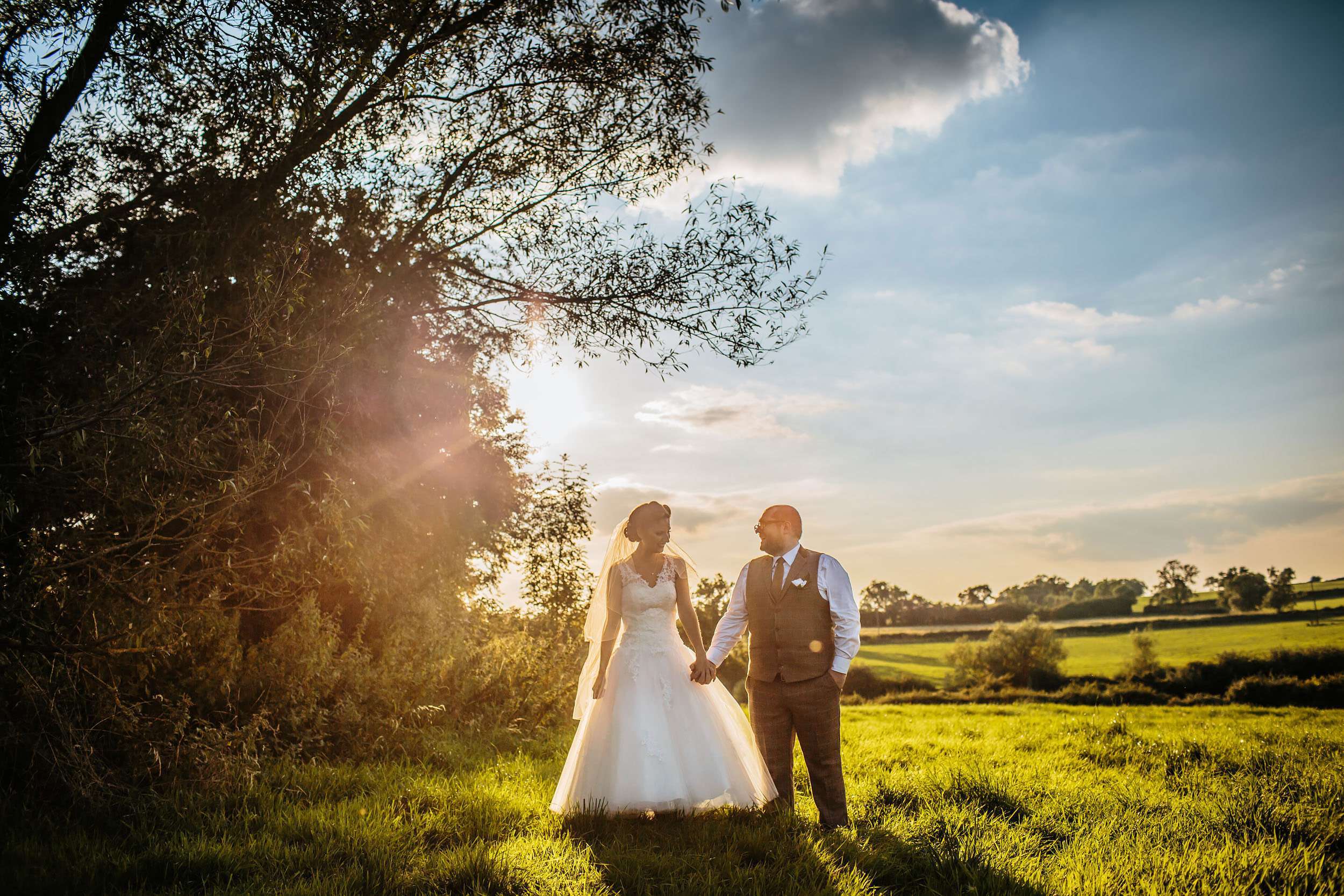 Bride and groom at sunset in a gorgeous field