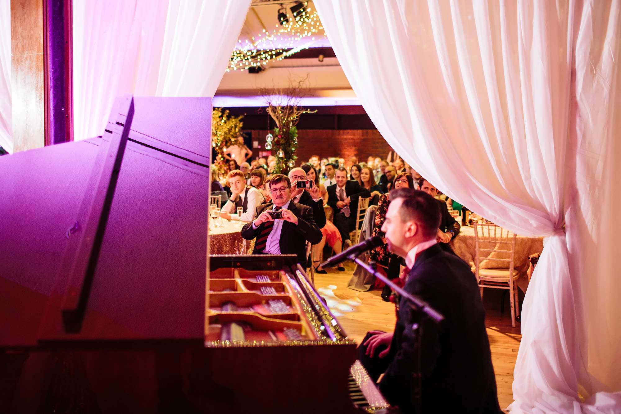 Groom plays the piano during his wedding speech