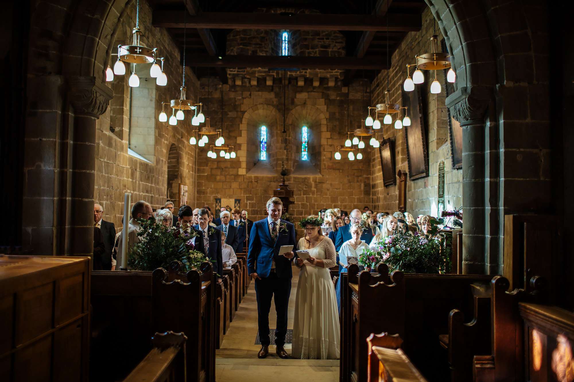 Bride and groom singing hymns in church at their wedding
