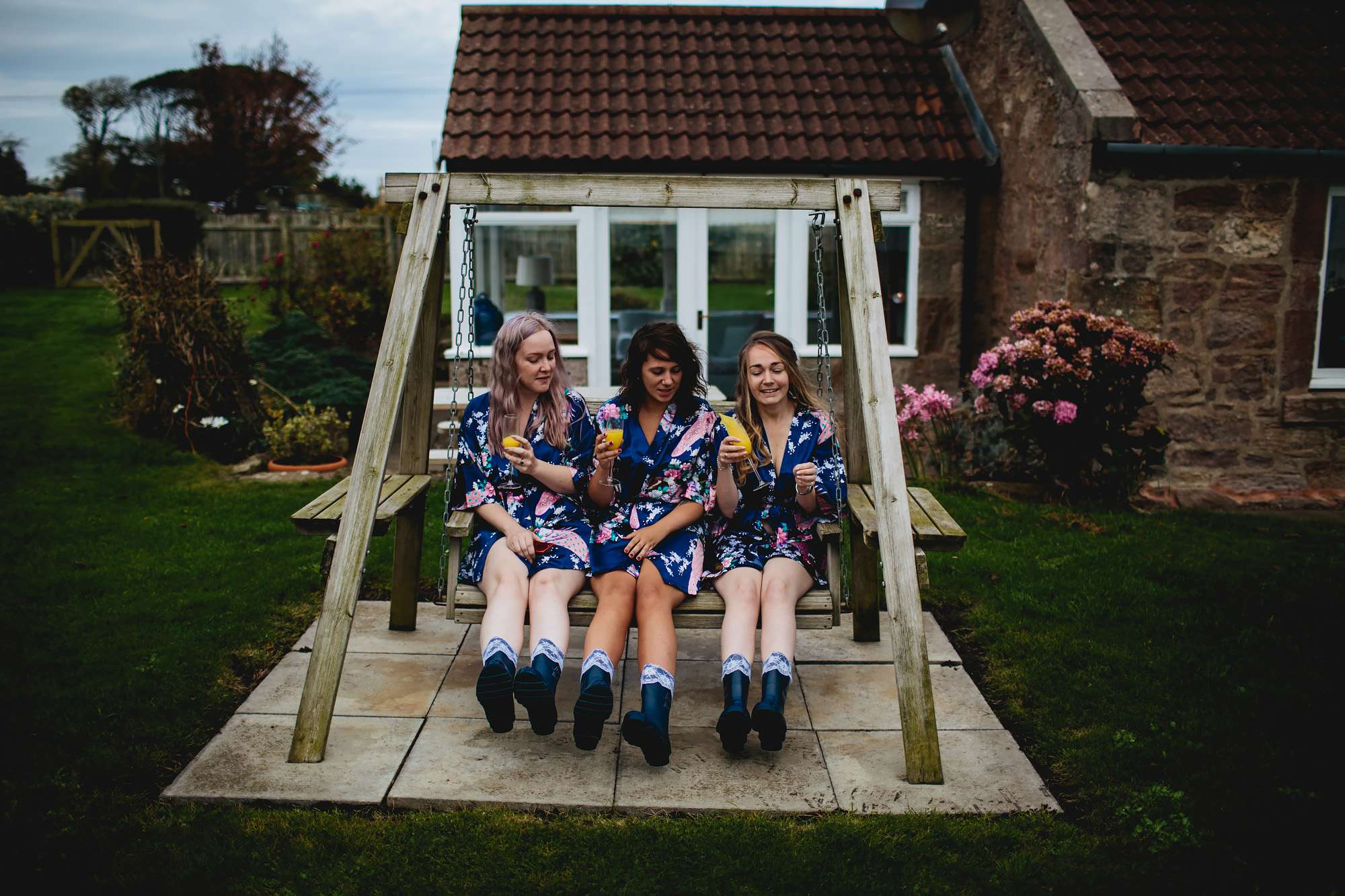 Bridesmaids laughing in matching dressing gowns