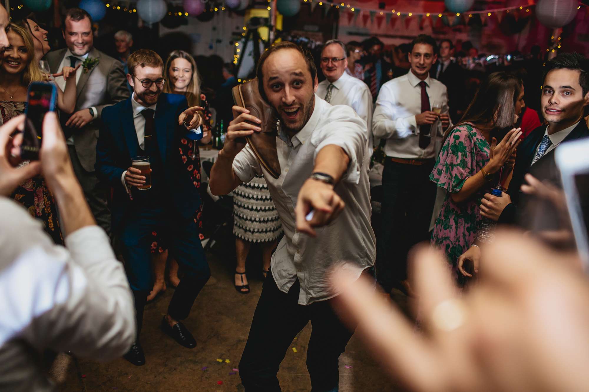 Wedding guest dancing with his shoe and it's funny
