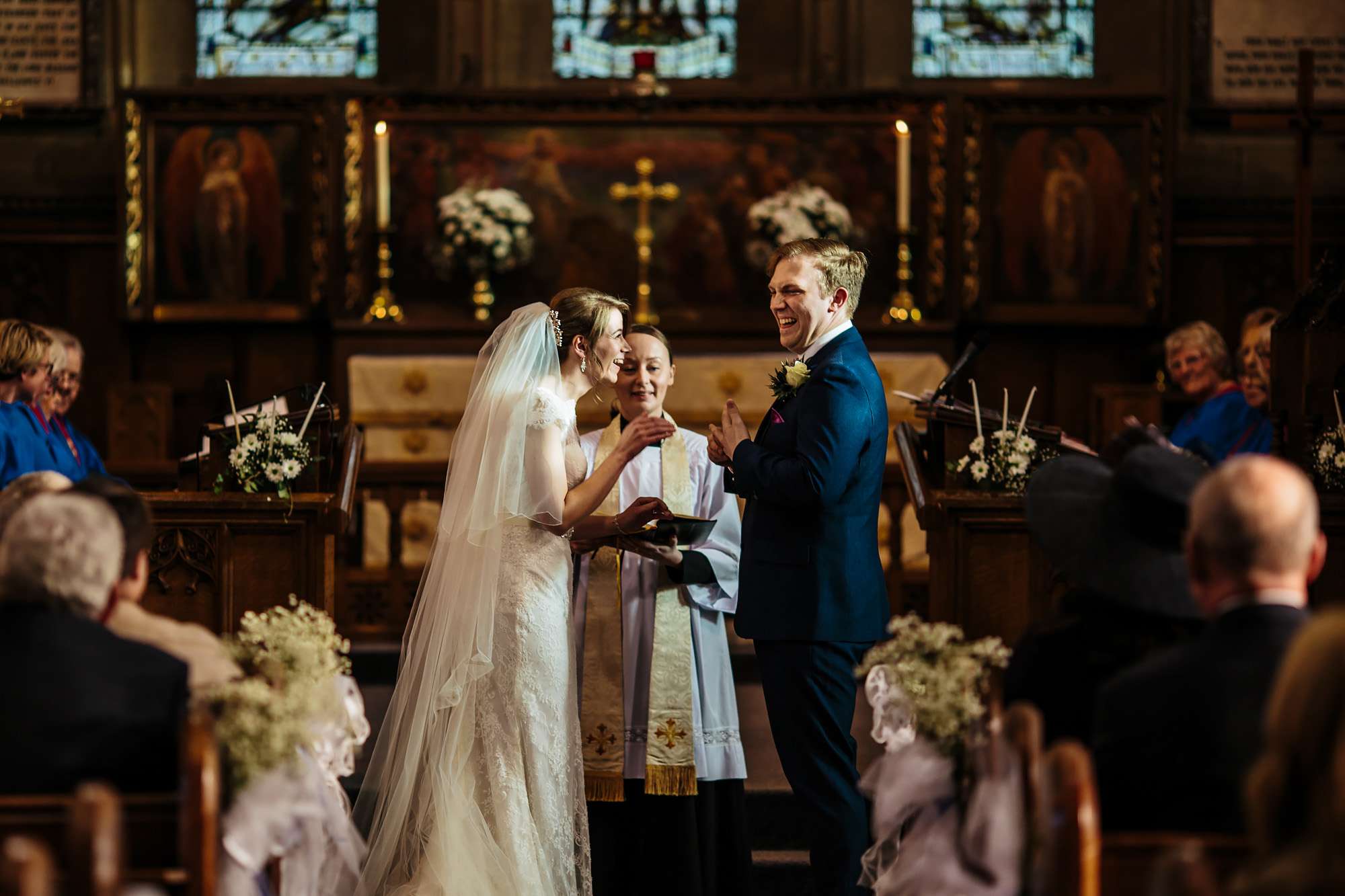 Bride and groom laughing during their church wedding ceremony
