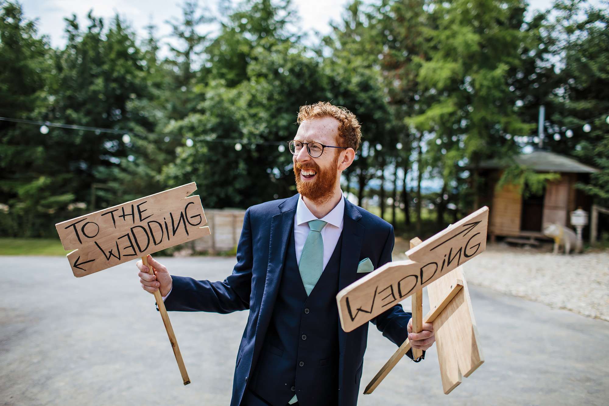 Groom with wedding signs in his hands