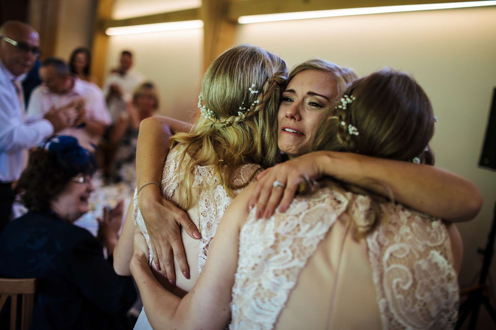Bride in tears at her wedding with bridesmaids