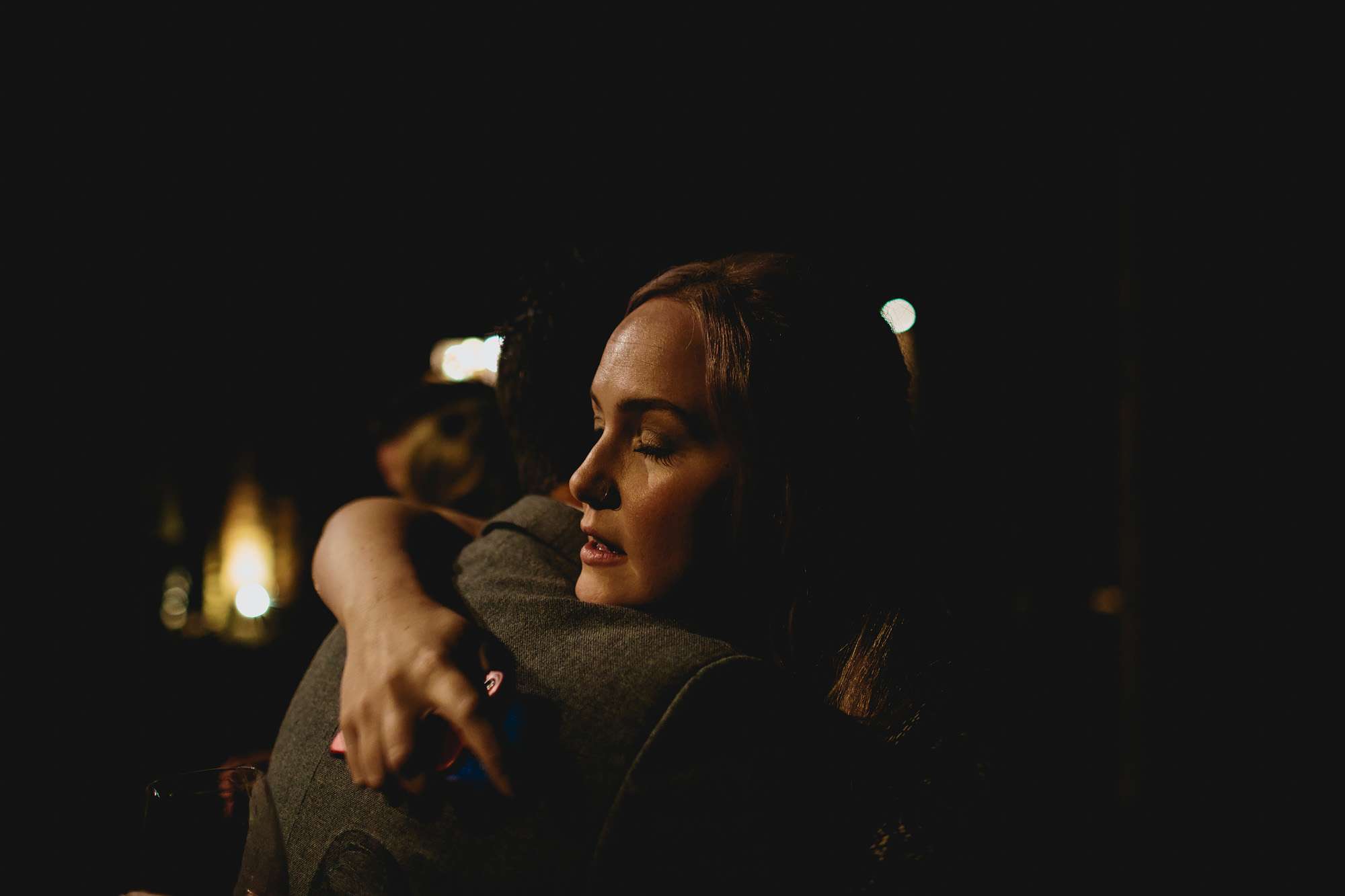 Wedding guests hugging at night time