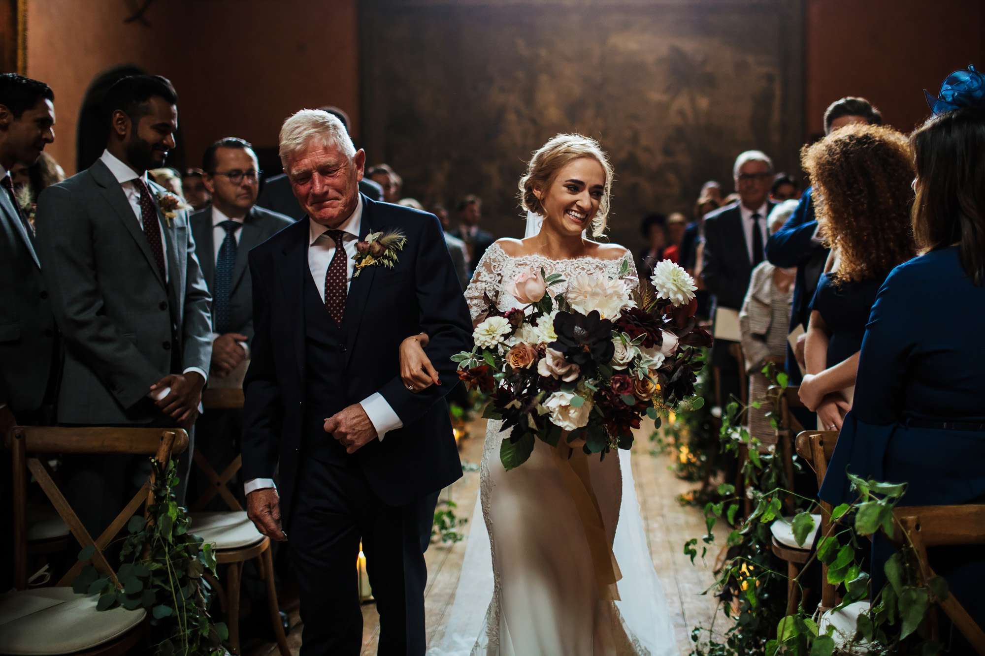 Bride and dad walking down the aisle at her wedding