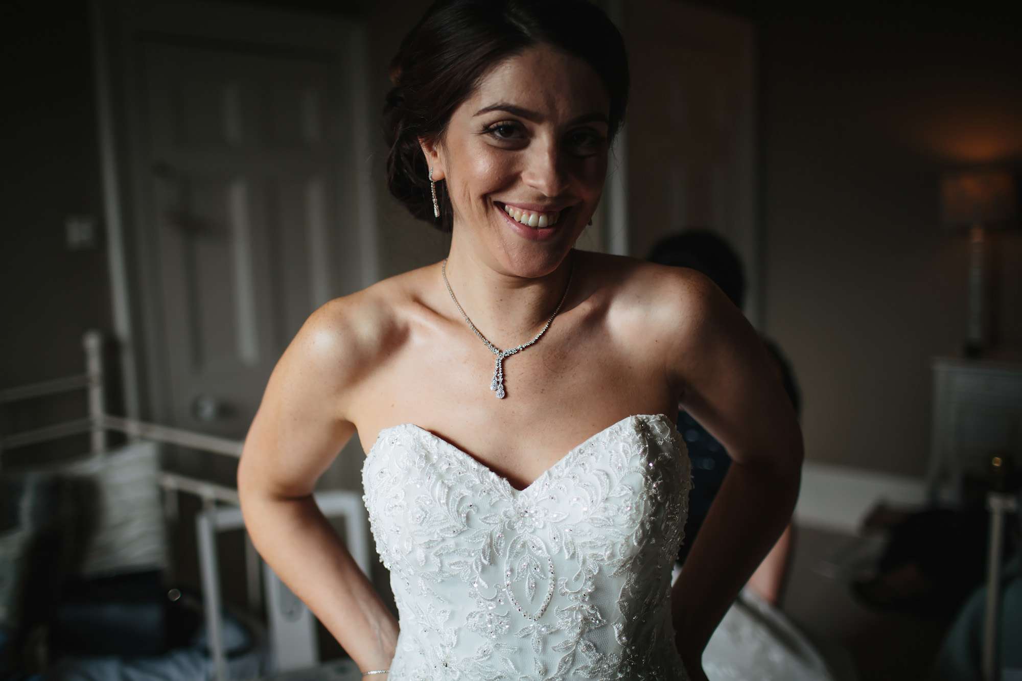 Bride smiling in her wedding dress during prep