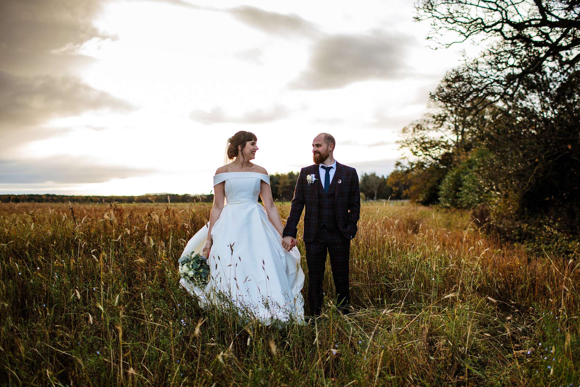 Bride and groom in a field at sunset in Leeds