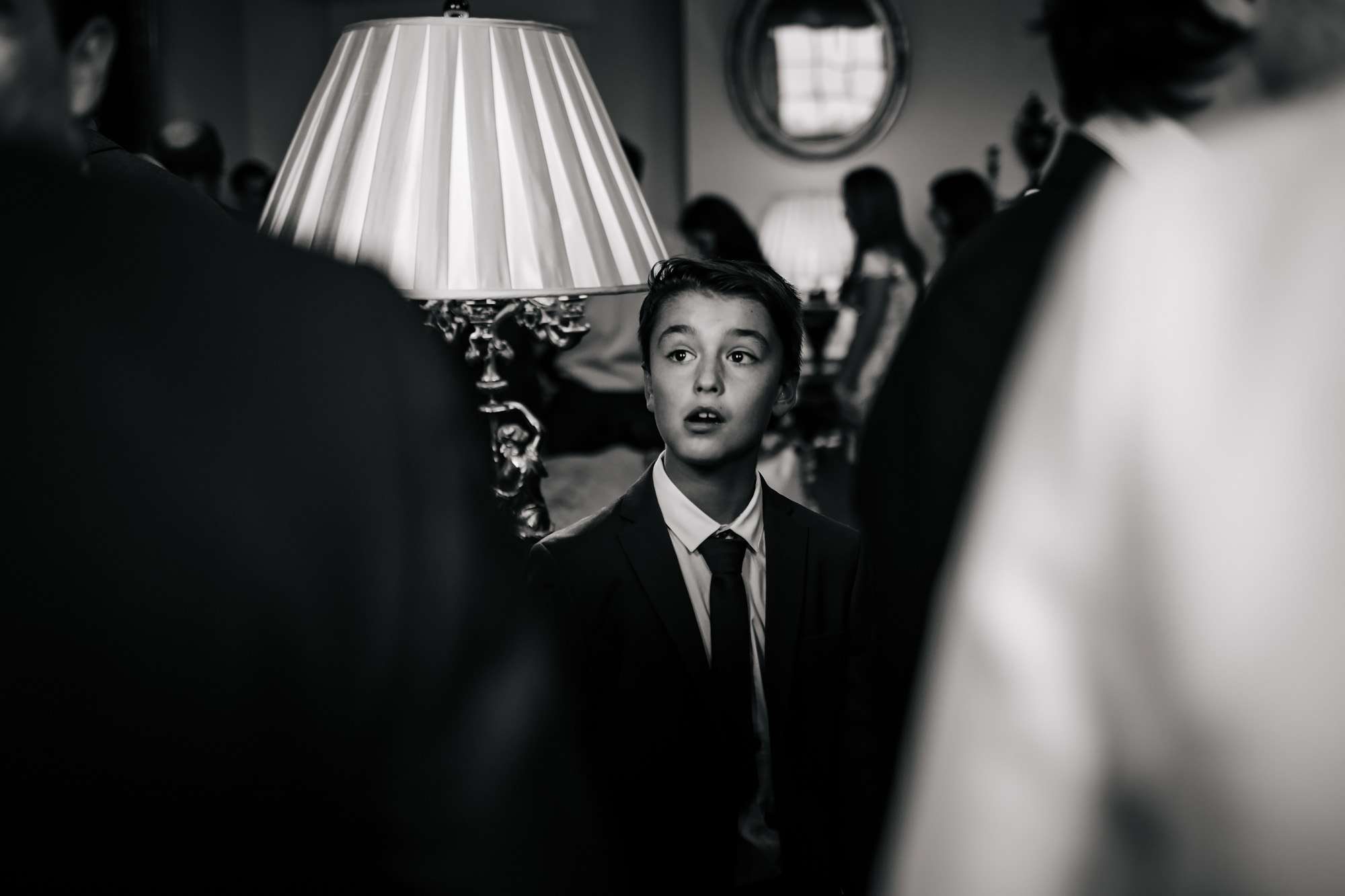 Black and white photo of a child at a wedding