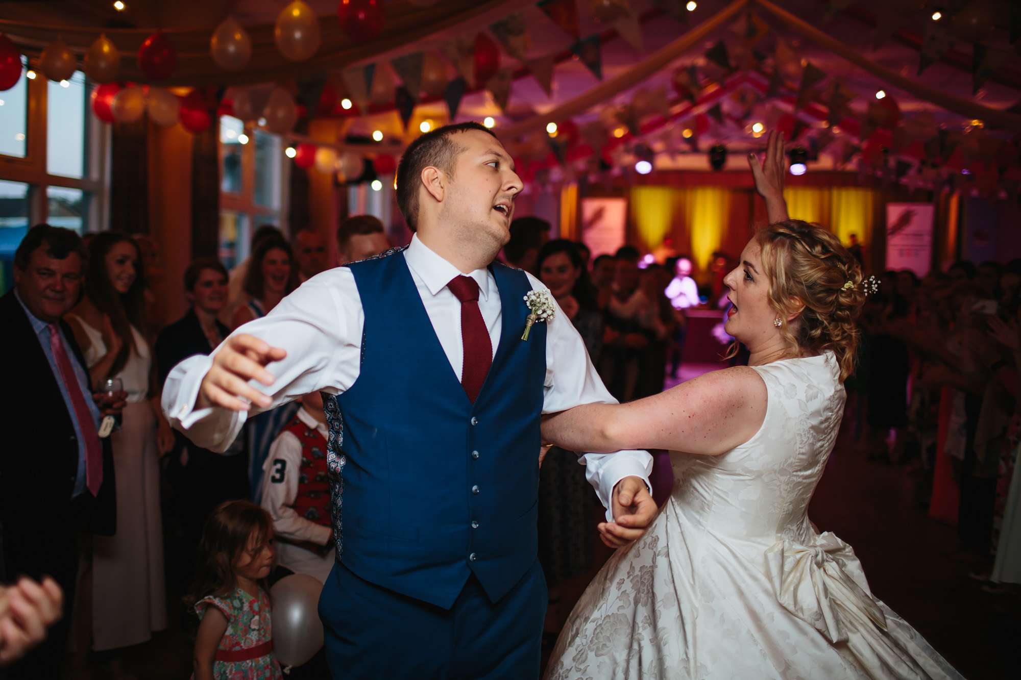 Bride and groom ceilidh dancing at their wedding in Yorkshire