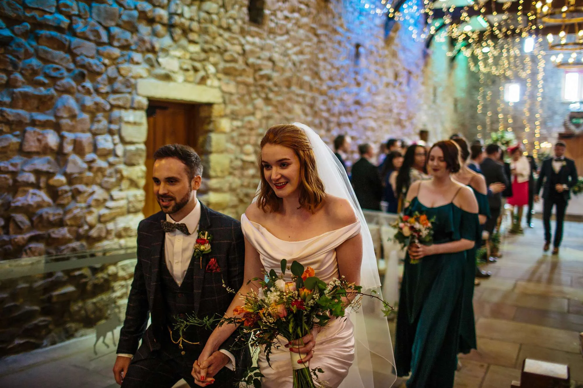 Bride and groom walk down the aisle at their wedding