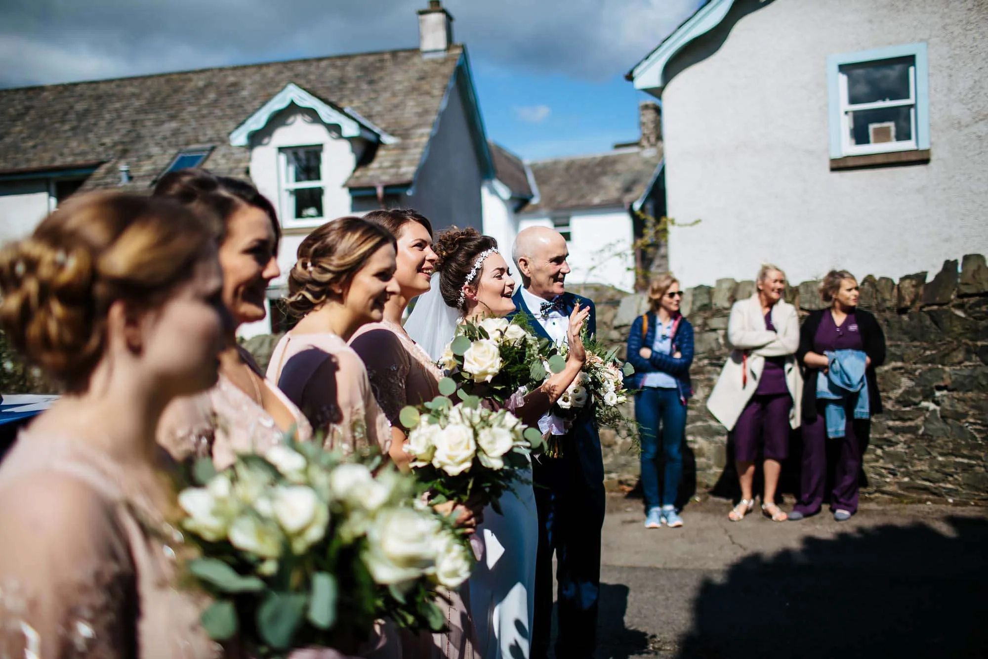 Bride and bridesmaids at a sunny Lake District wedding