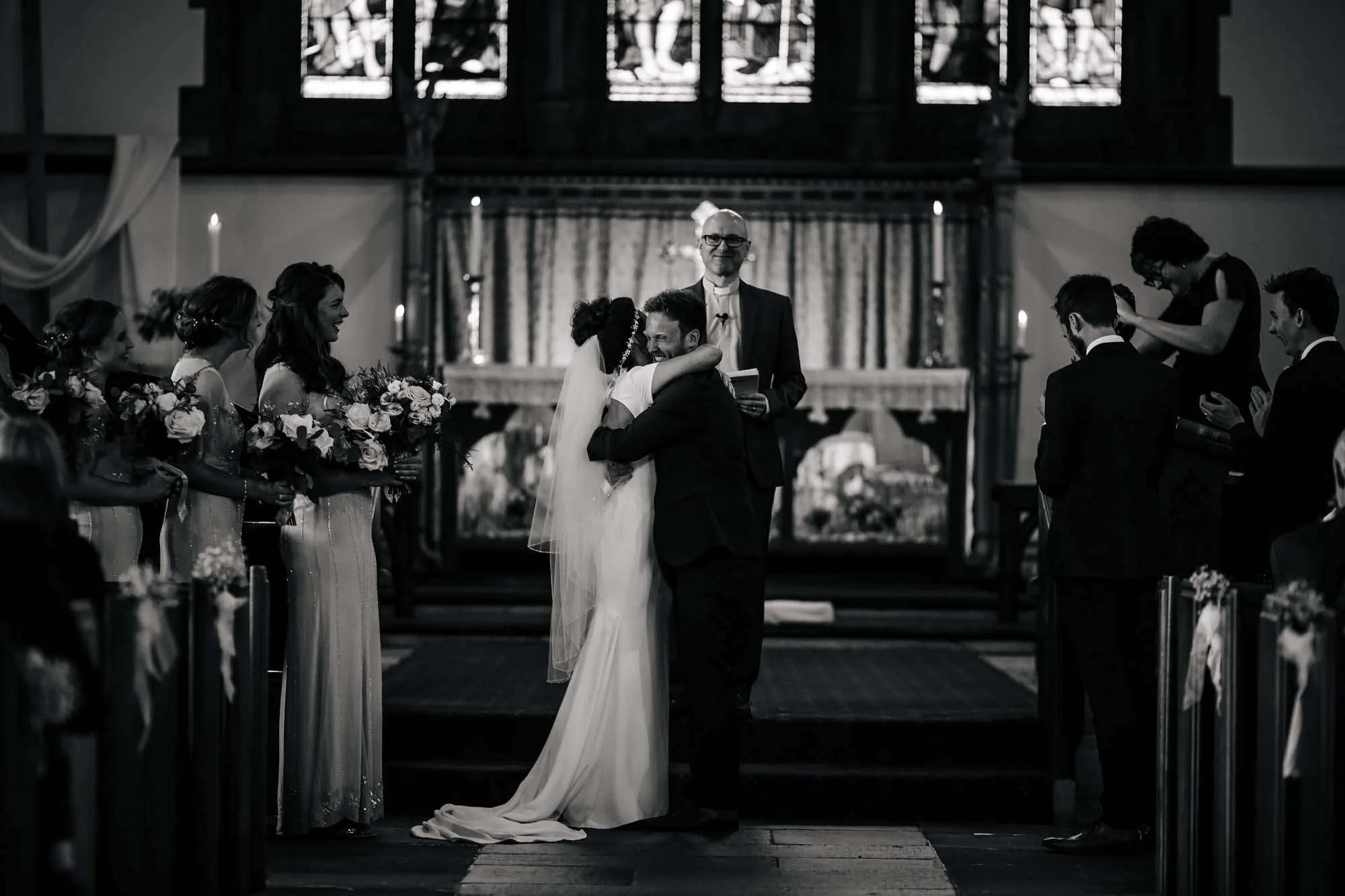 Bride and groom hugging at the altar in church