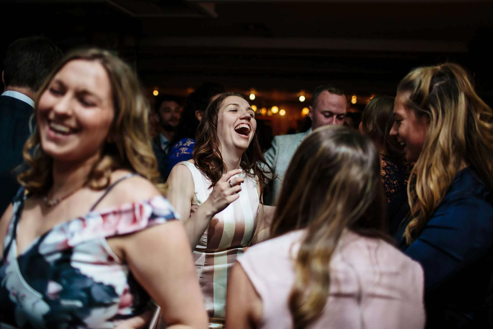 Wedding guests laughing on the dance floor