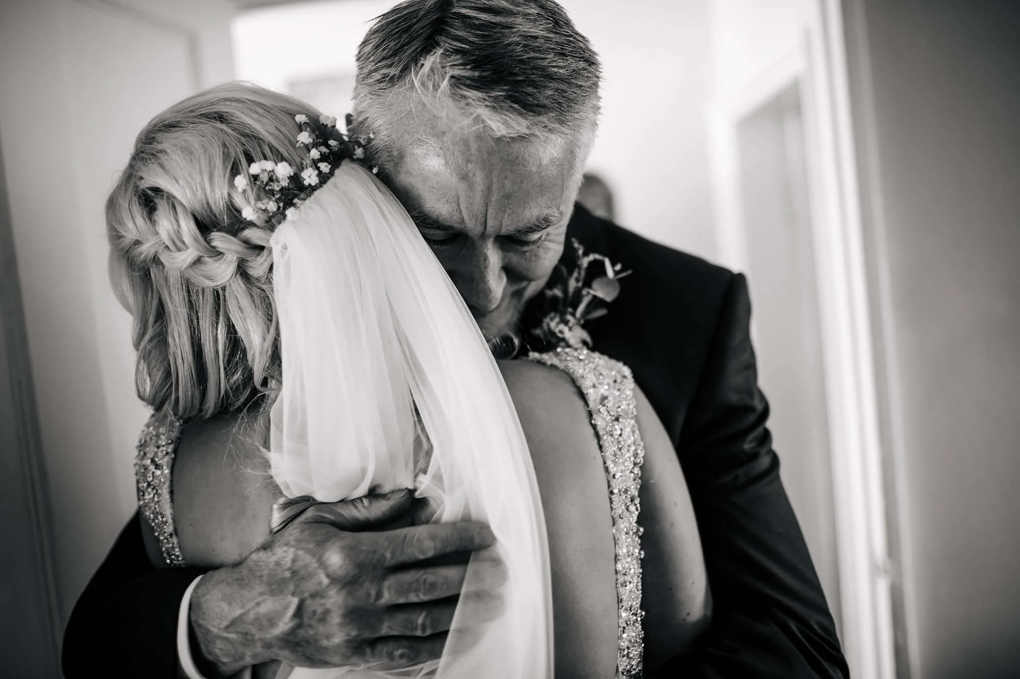 An emotional father and bride hug on her wedding morning in Leeds