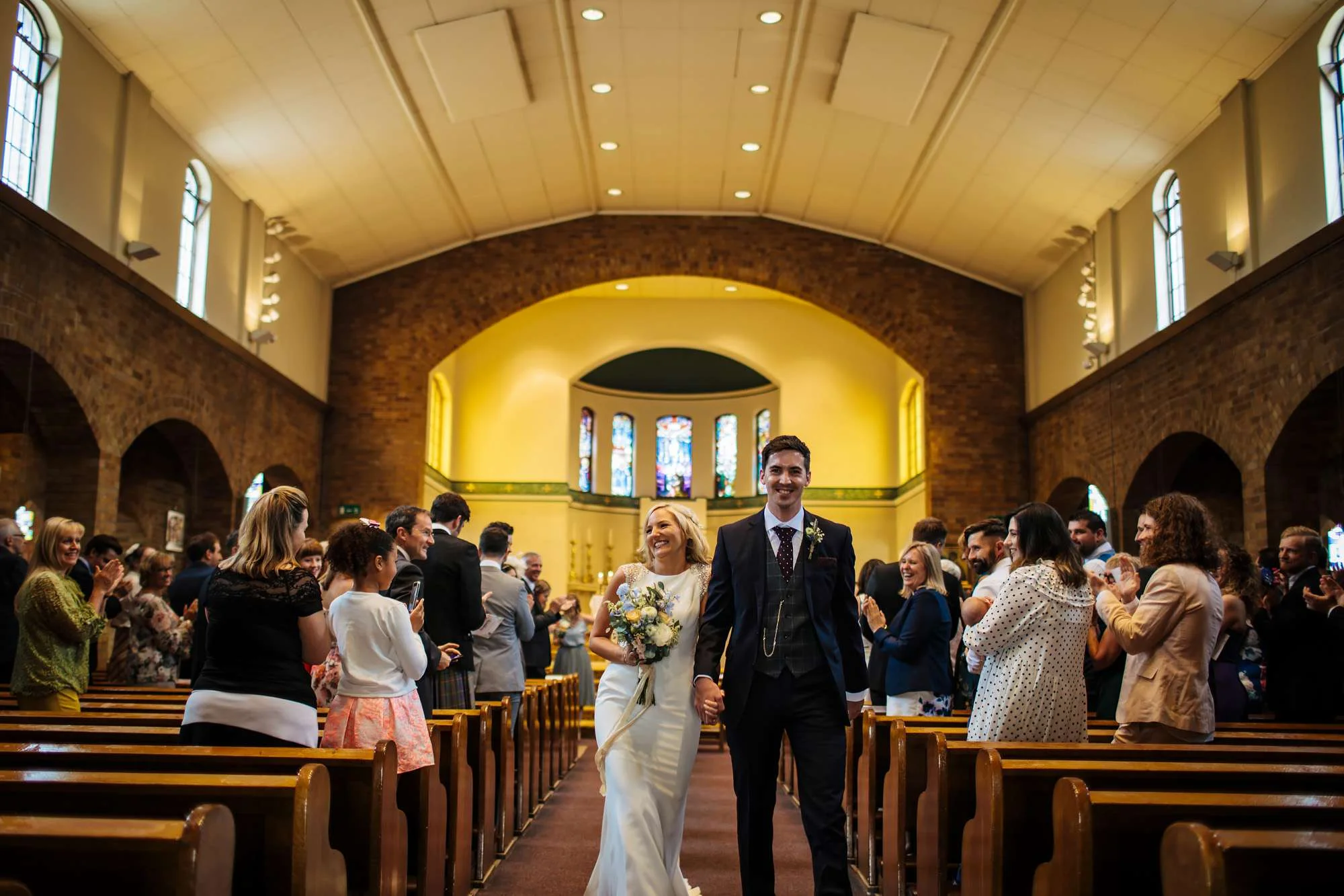 Bride and groom walking down the aisle in Leeds at their wedding