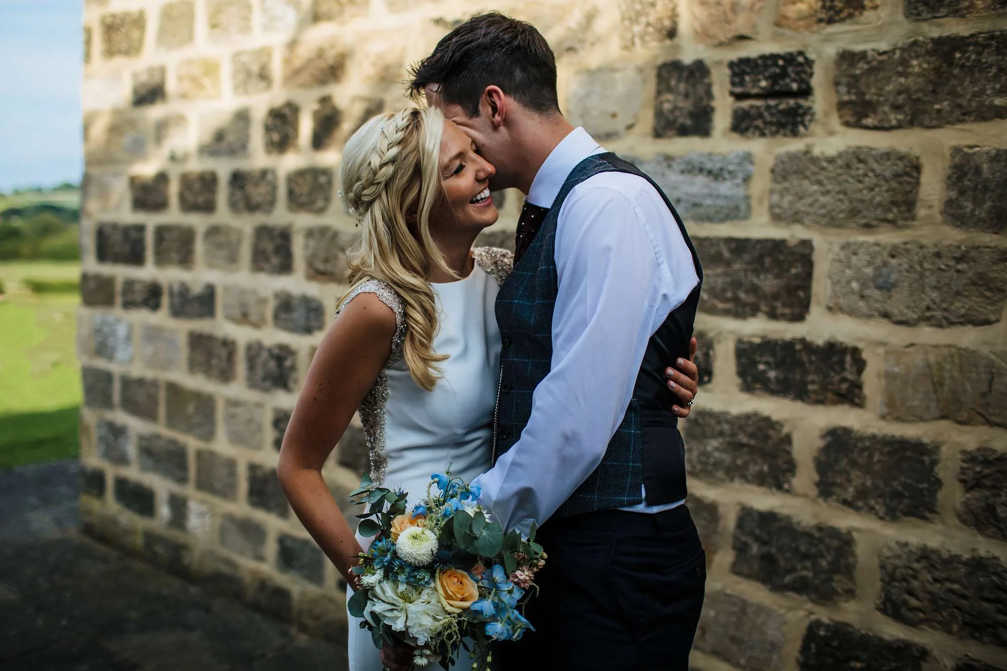 Bride and groom posing at East Keswick Village Hall
