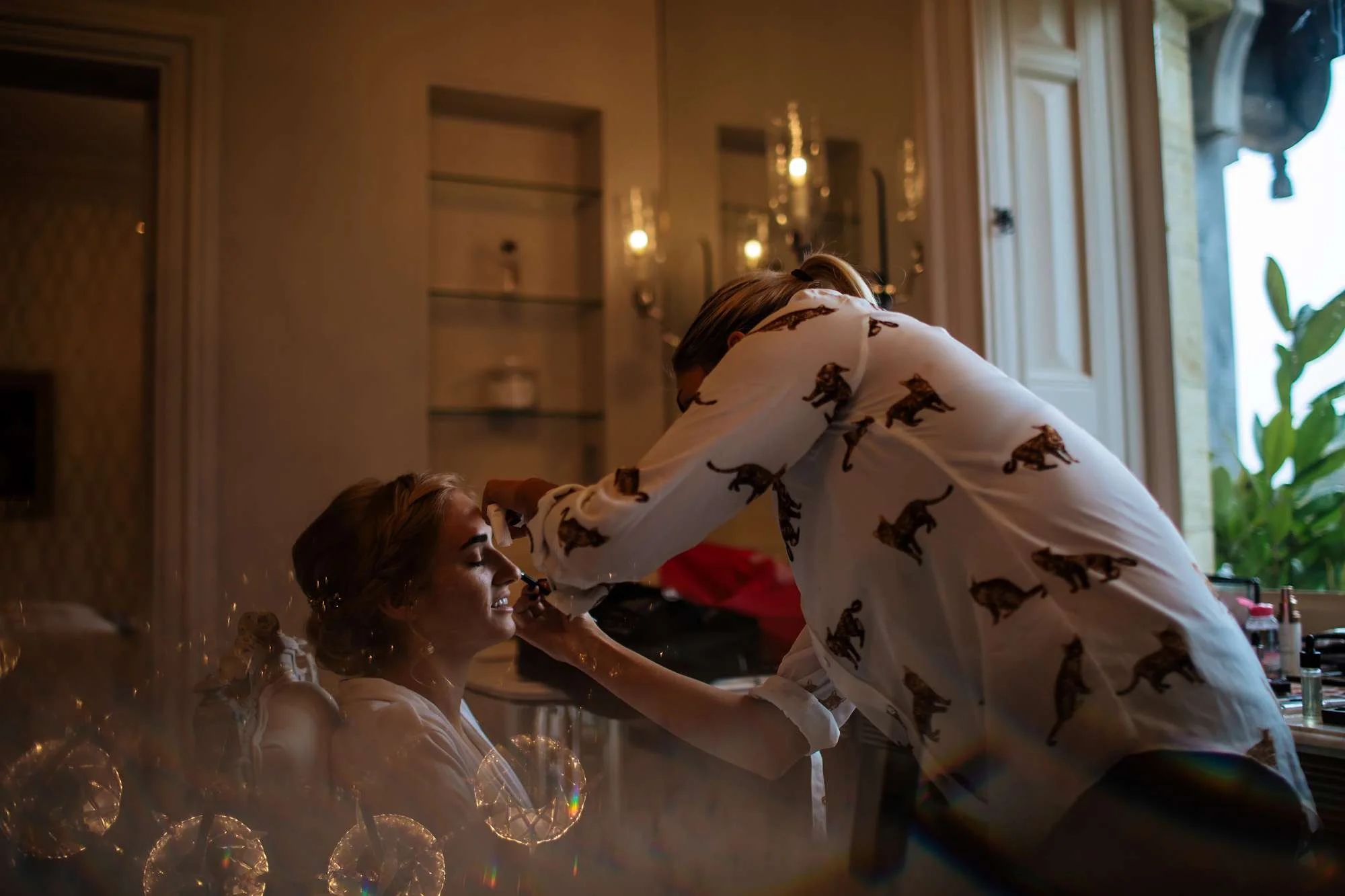 Bride having her make up applied before her wedding