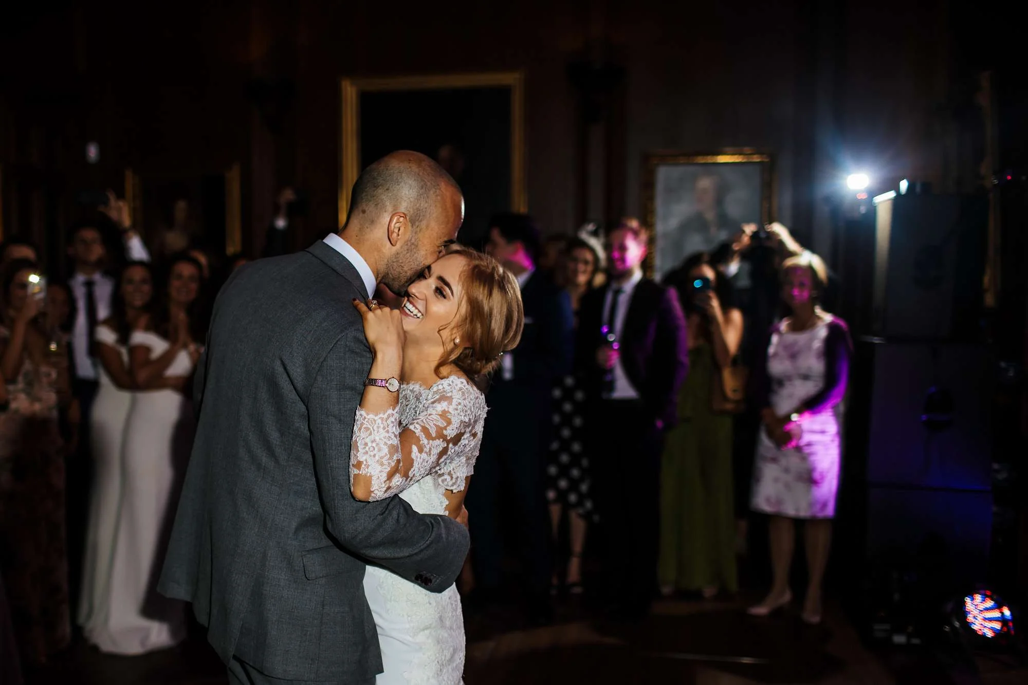 Bride and groom hug on the dance floor