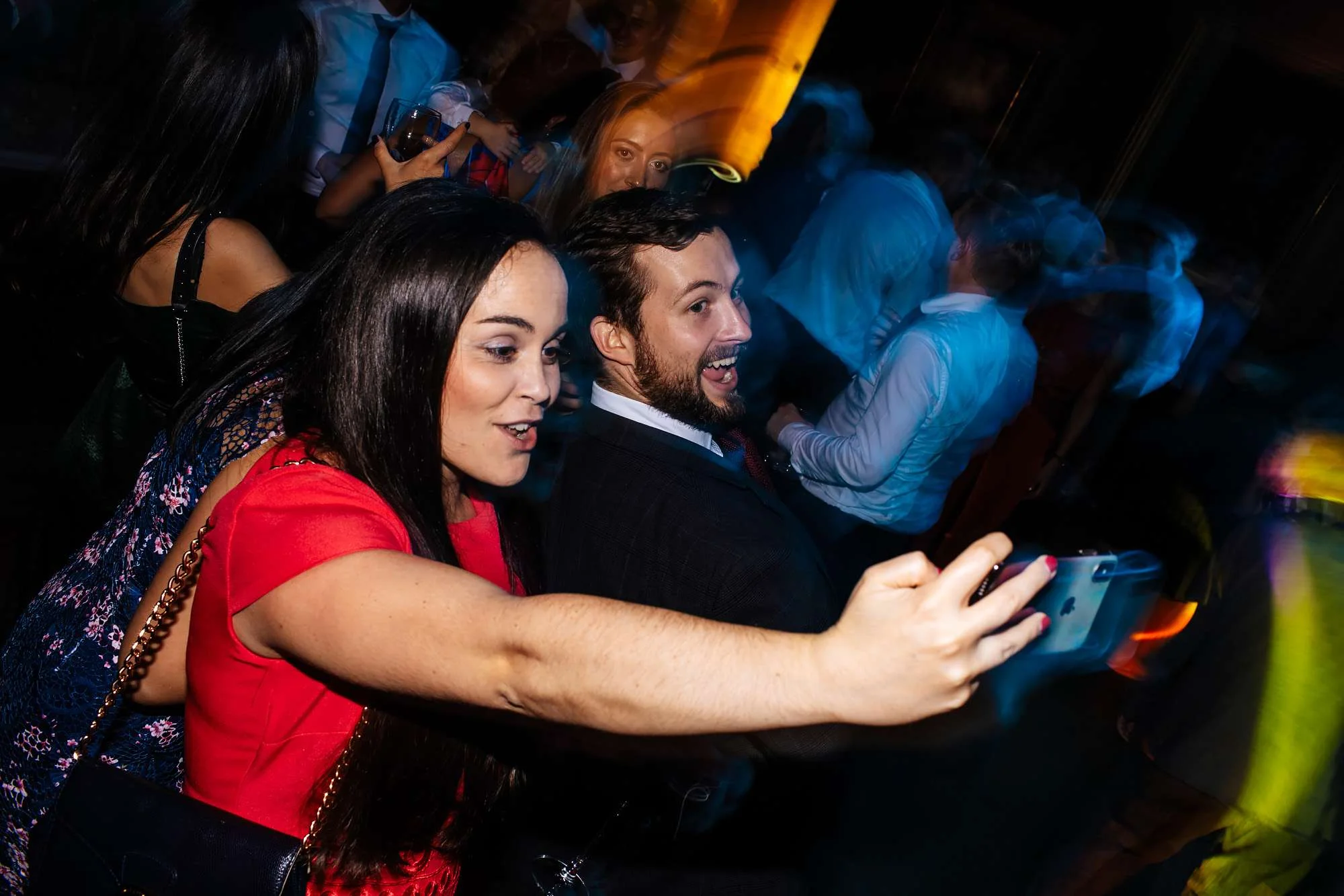 Wedding guests taking selfies and laughing