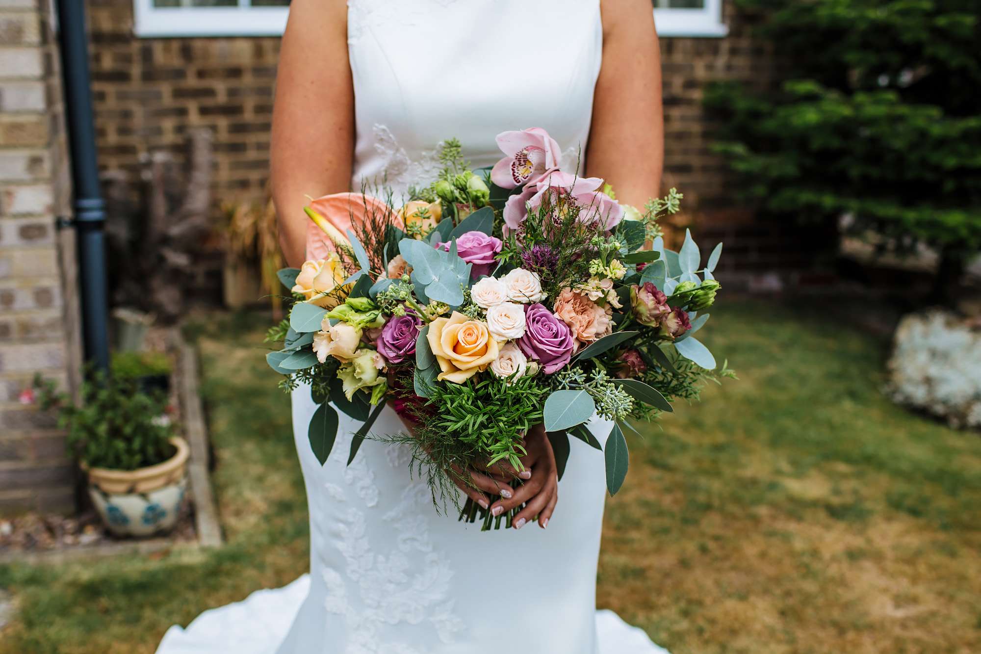 Bride holds her bouquet at her wedding