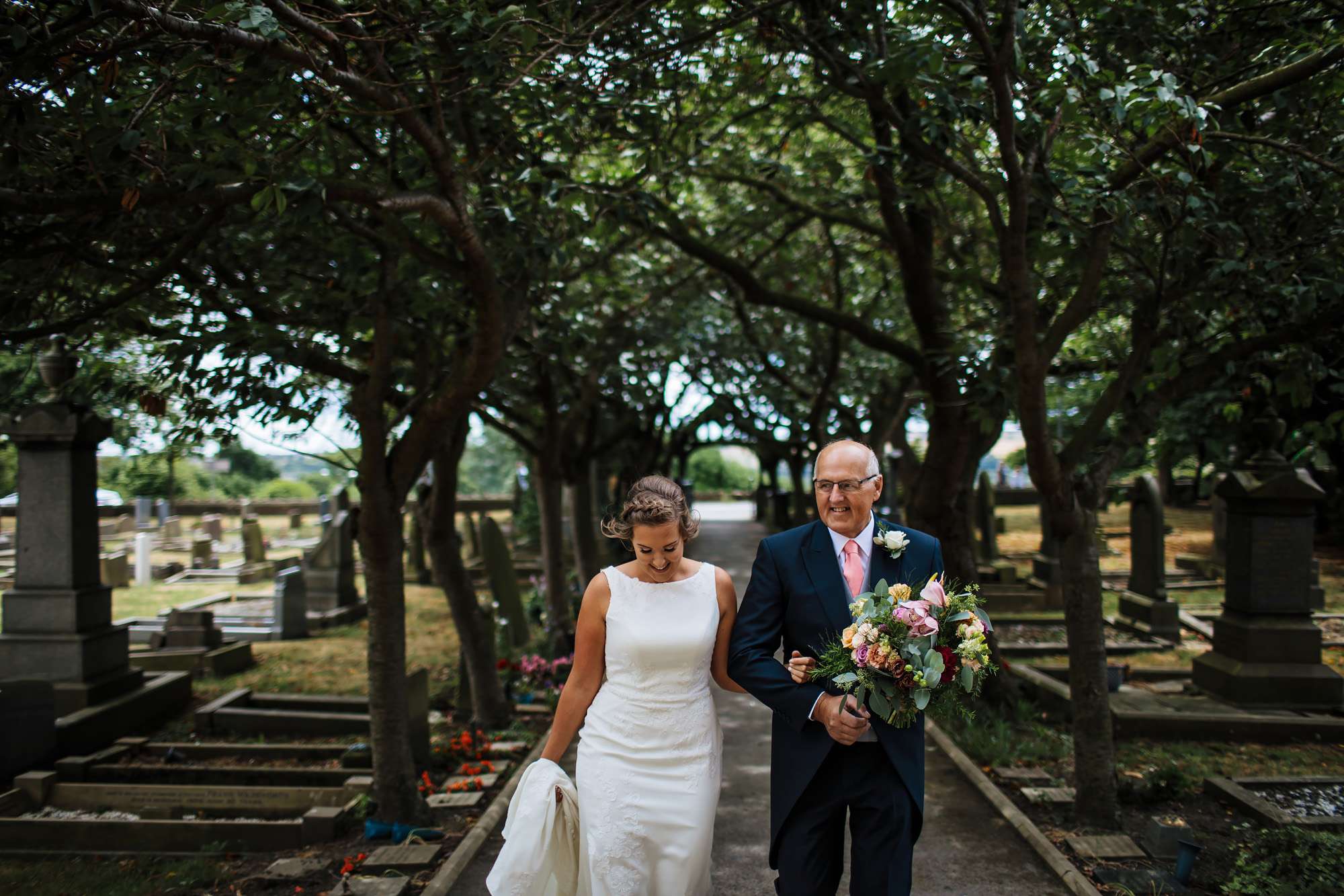 Bride and father walking to the church on her wedding day
