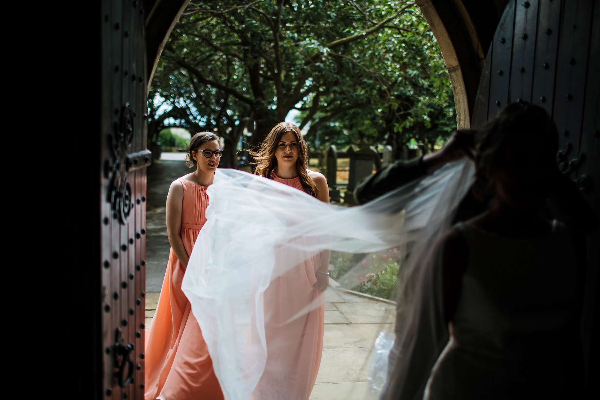 Bride's dress blowing in the wind at the church