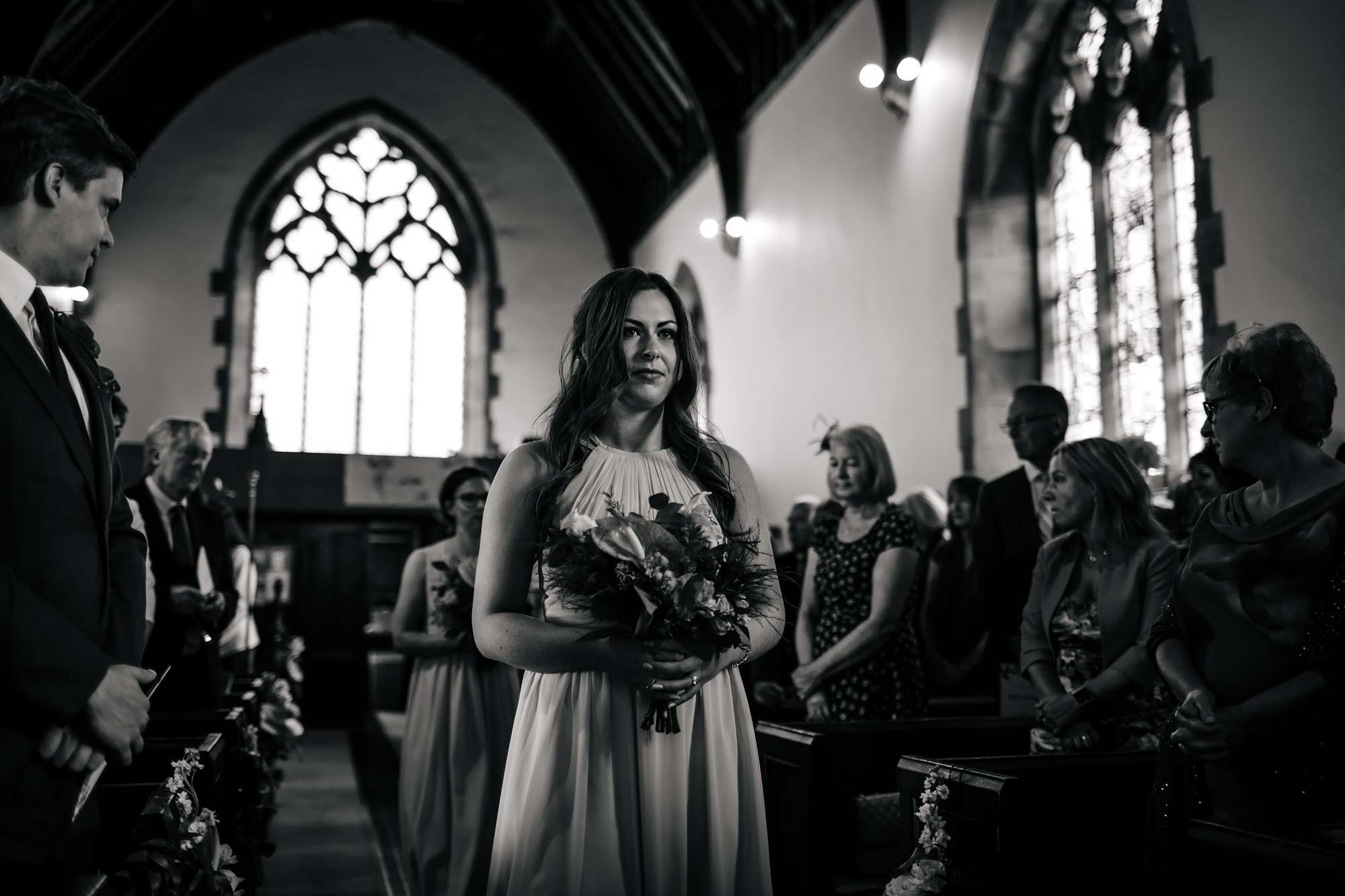 Bridesmaid walking down the church aisle