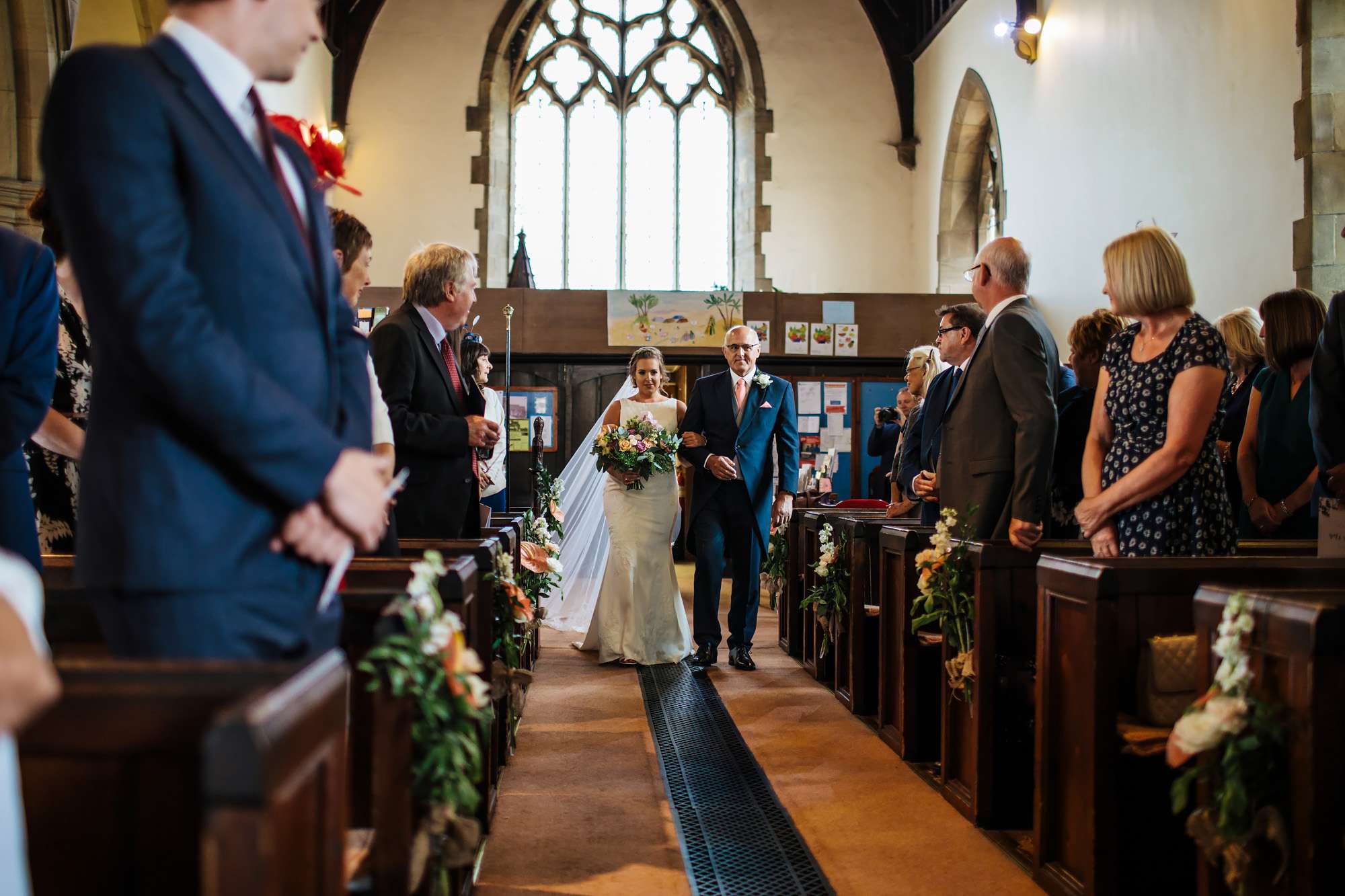 Bride and father walking down the aisle at a wedding