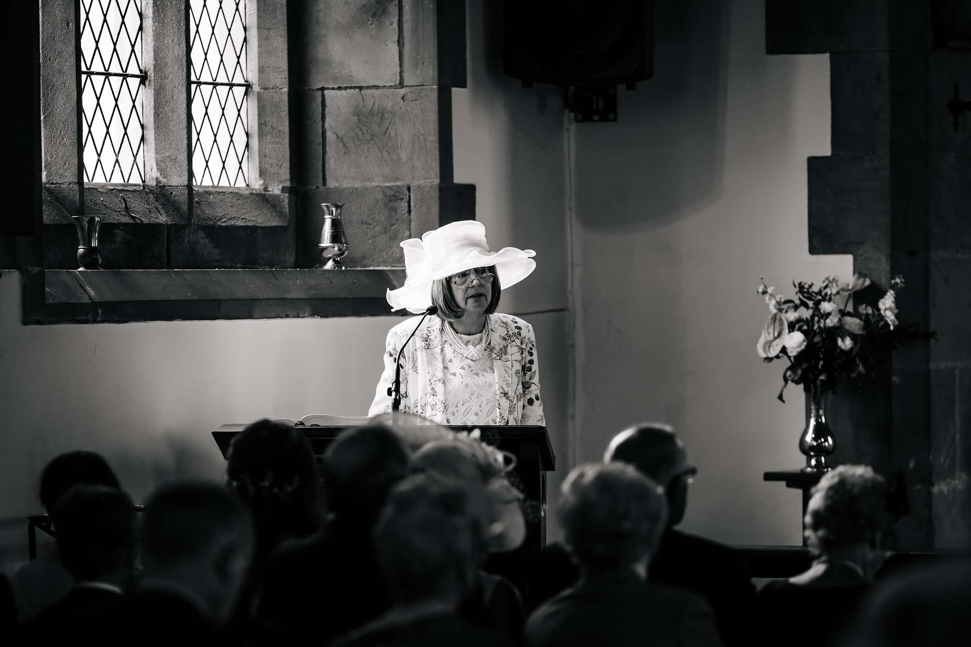 Bride's mother performs a reading in the church wedding